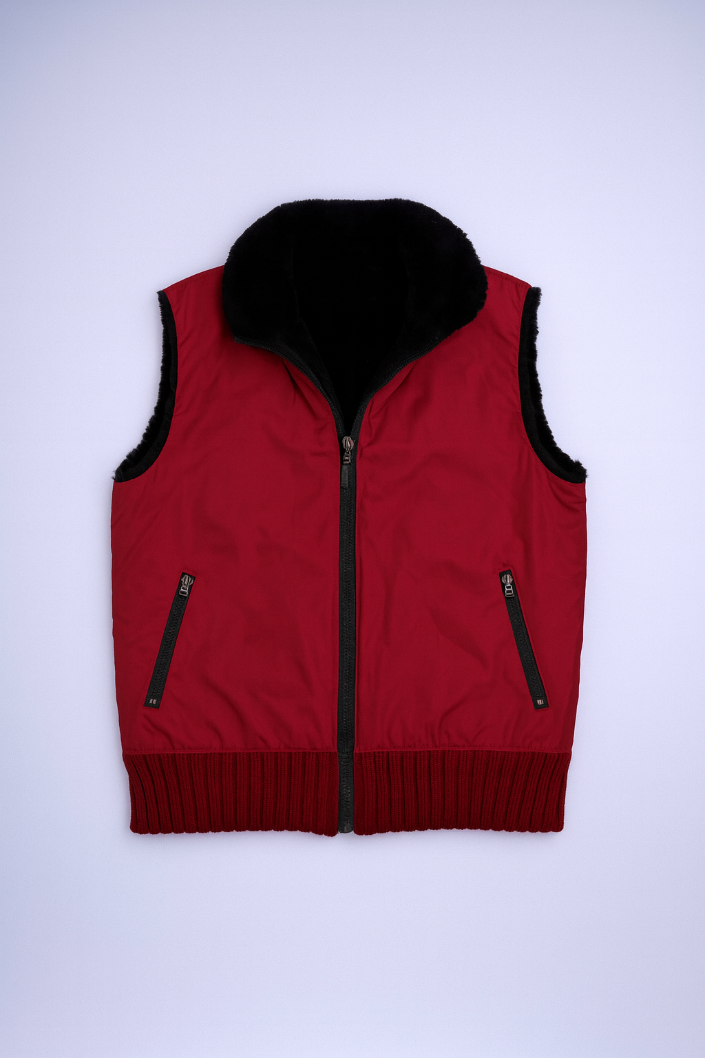 Red sleeveless vest with black faux fur collar and zippered pockets for sporty-casual layering.