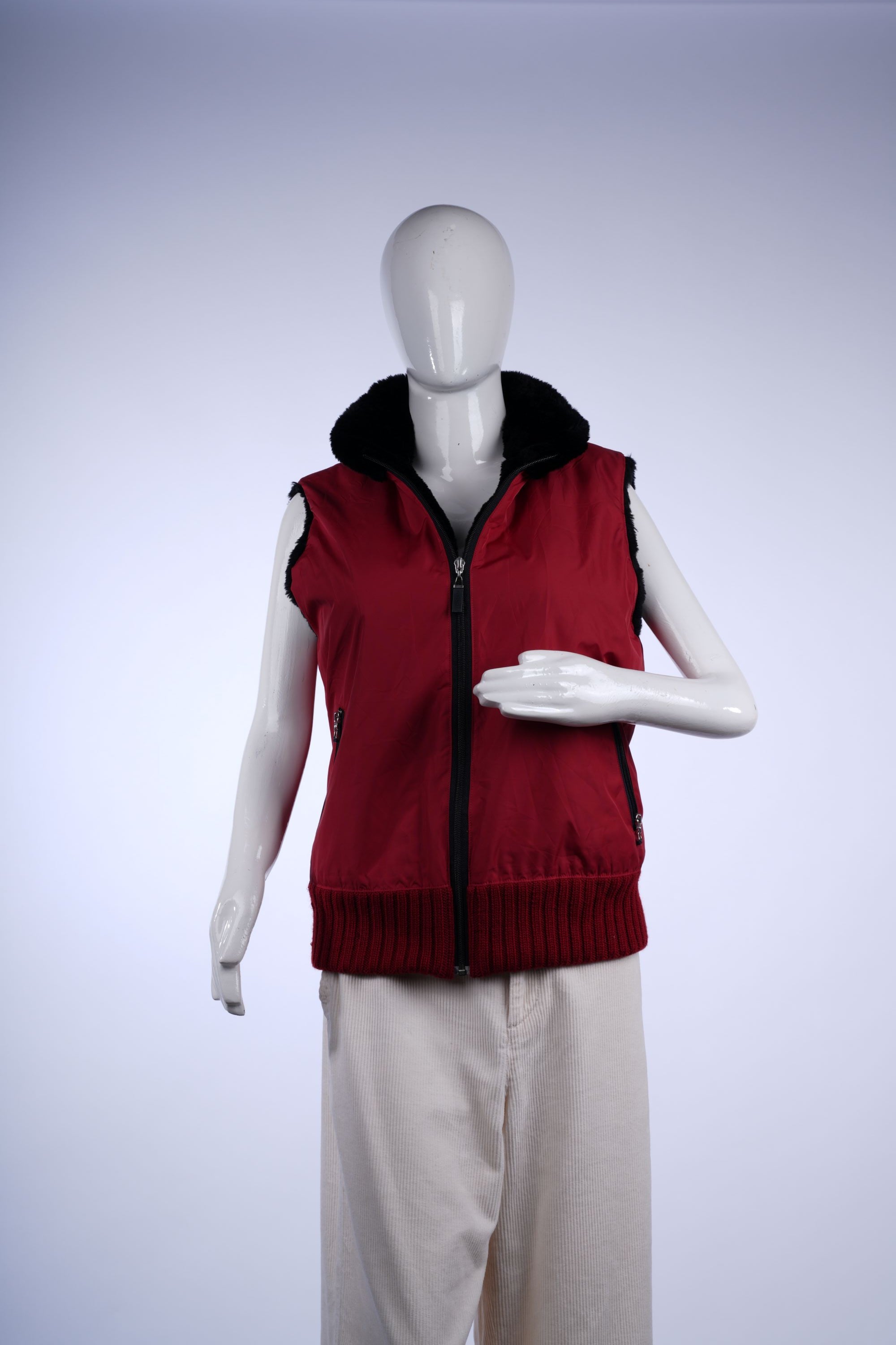 Warm red vest featuring plush black lining and full-zip front for stylish winter wear.