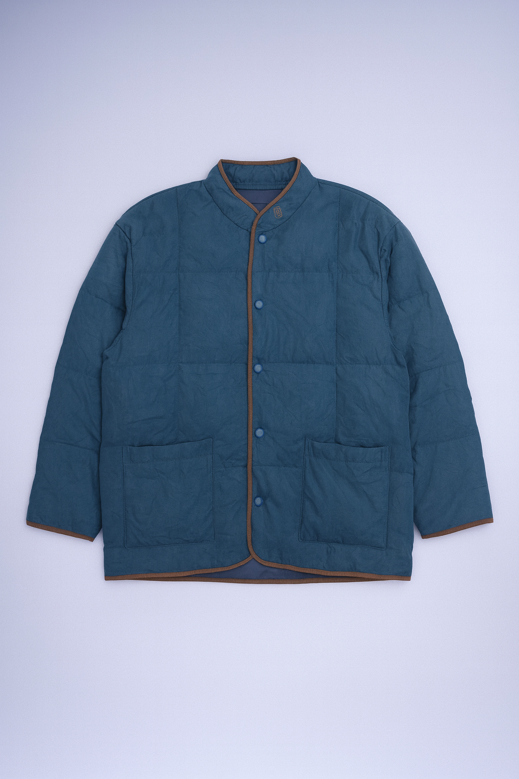 Balmain quilted puffer jacket with stand-up collar and signature "B" logo, insulated for cold-weather wear.