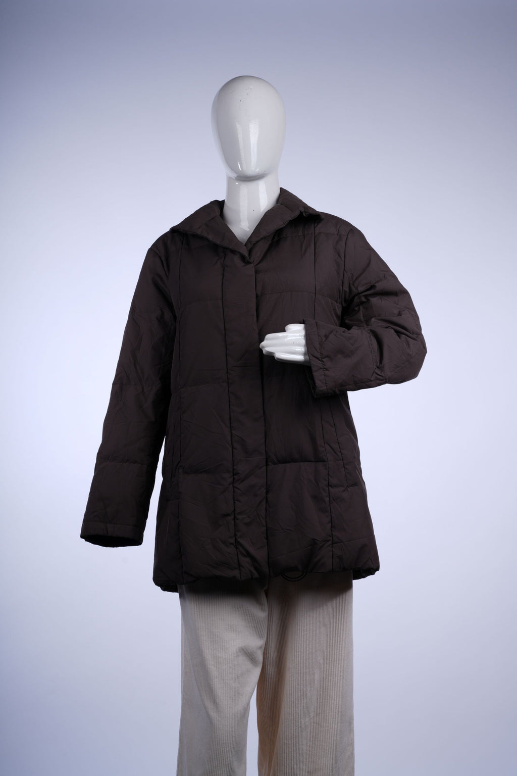 Mid-length brown puffer jacket featuring quilted design, stand collar, and winter-ready insulation.