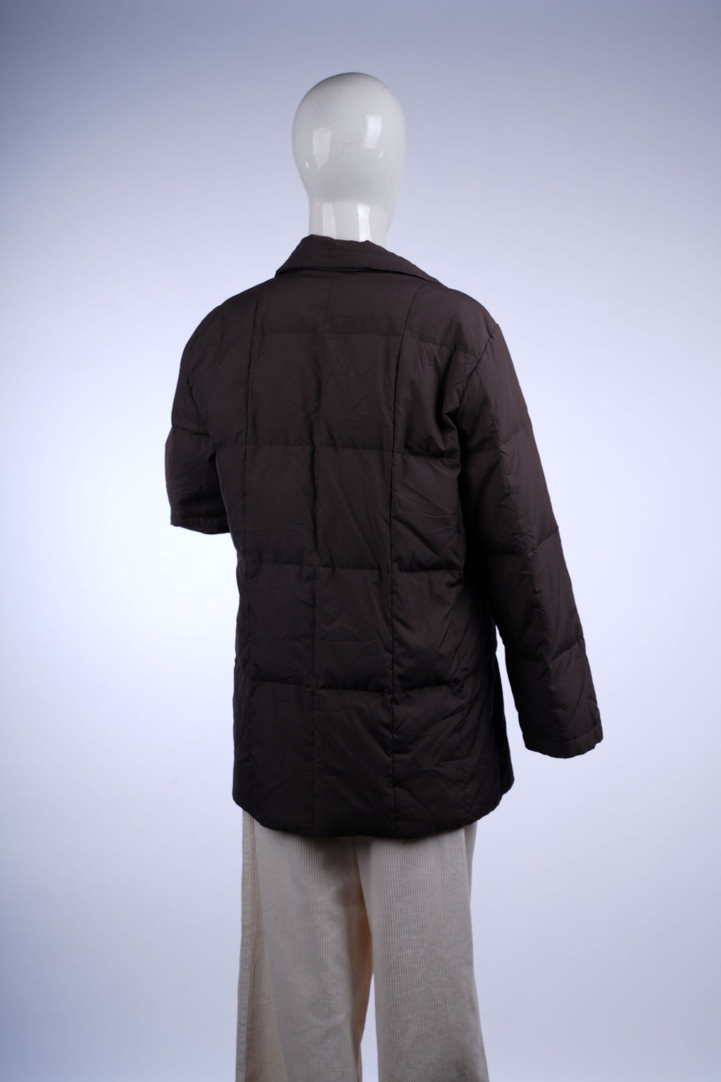 Insulated brown puffer coat with stand-up collar and mid-thigh length for cozy winter wear.