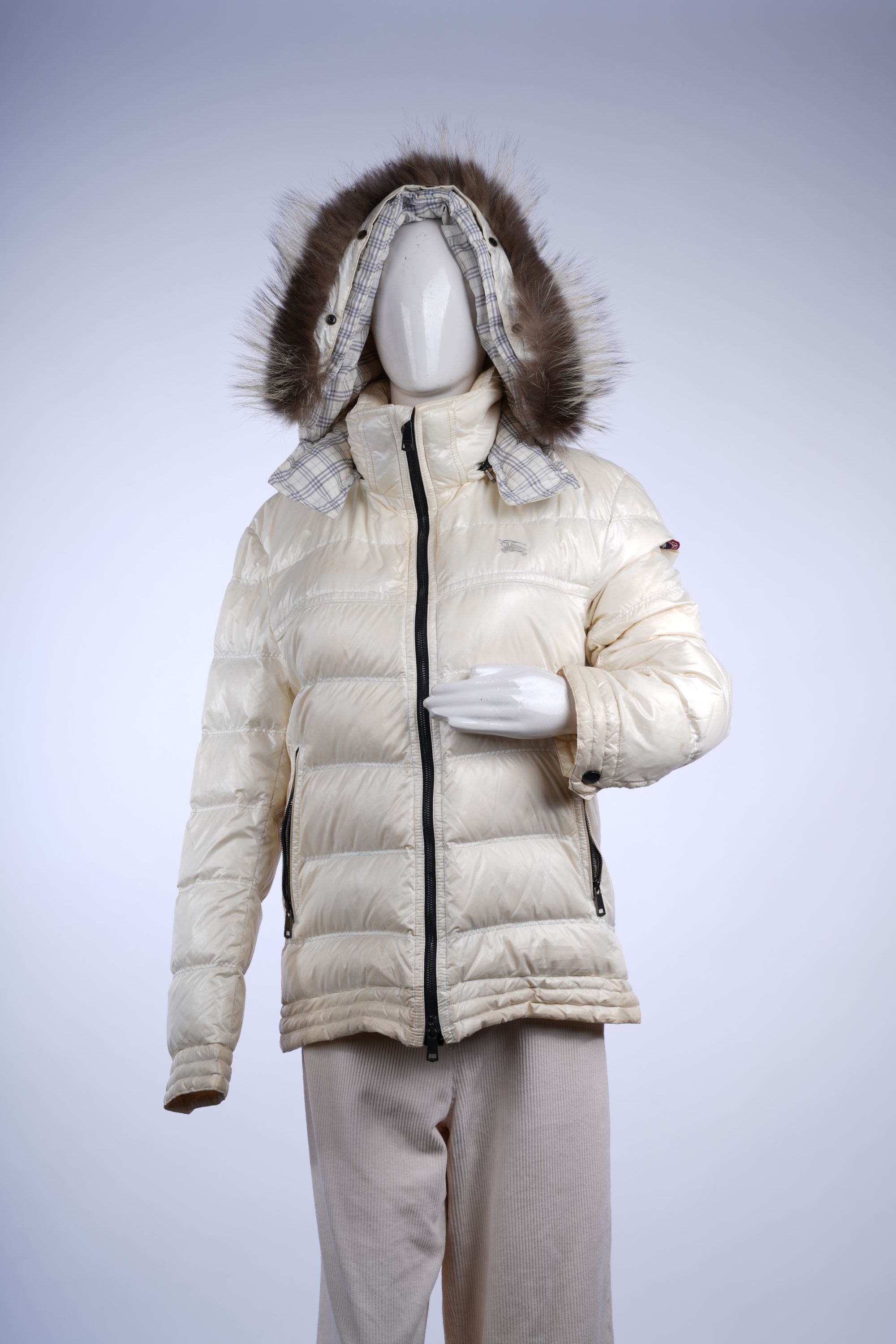 Luxury Burberry Black Label insulated jacket featuring padded body, fur hood, and signature check interior.