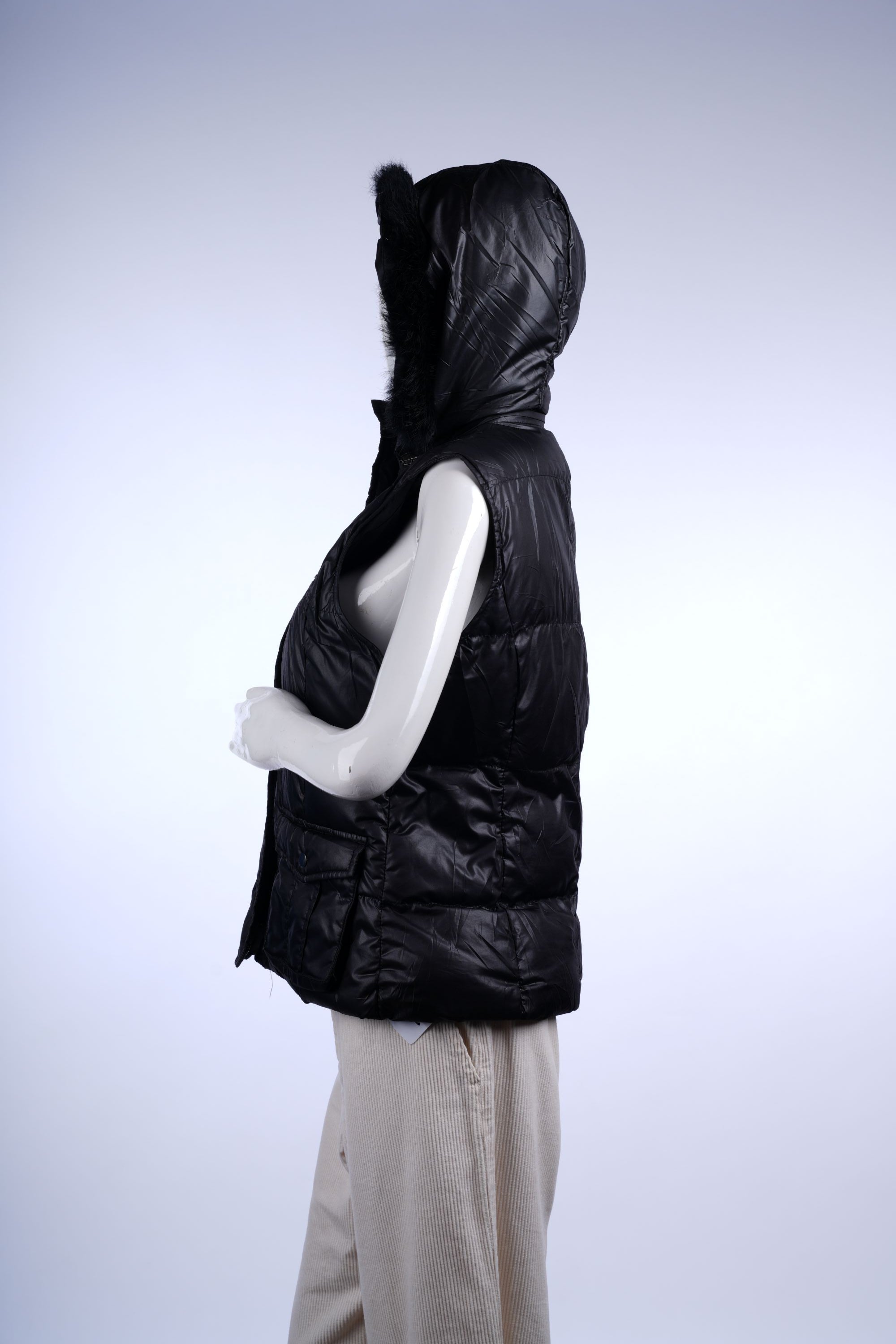 Insulated black vest with fur-trimmed design, front pockets, and zip closure for cold-weather wear.