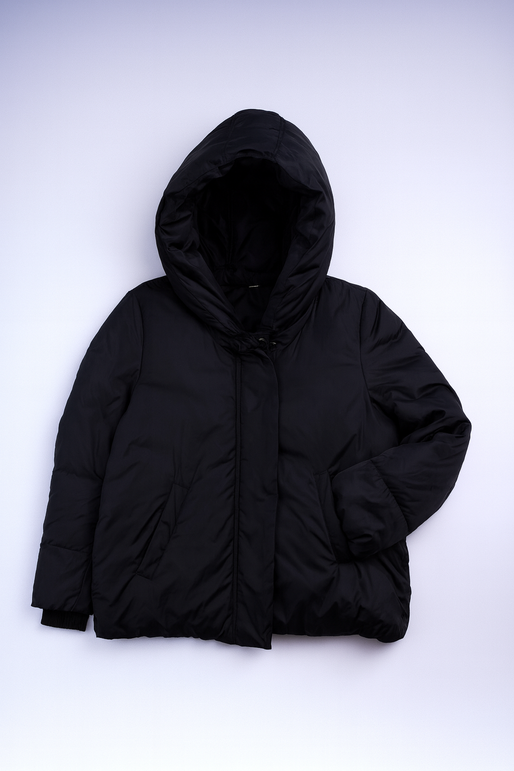 Long quilted puffer coat with high collar and full-length zipper, providing warmth and cold-weather protection.