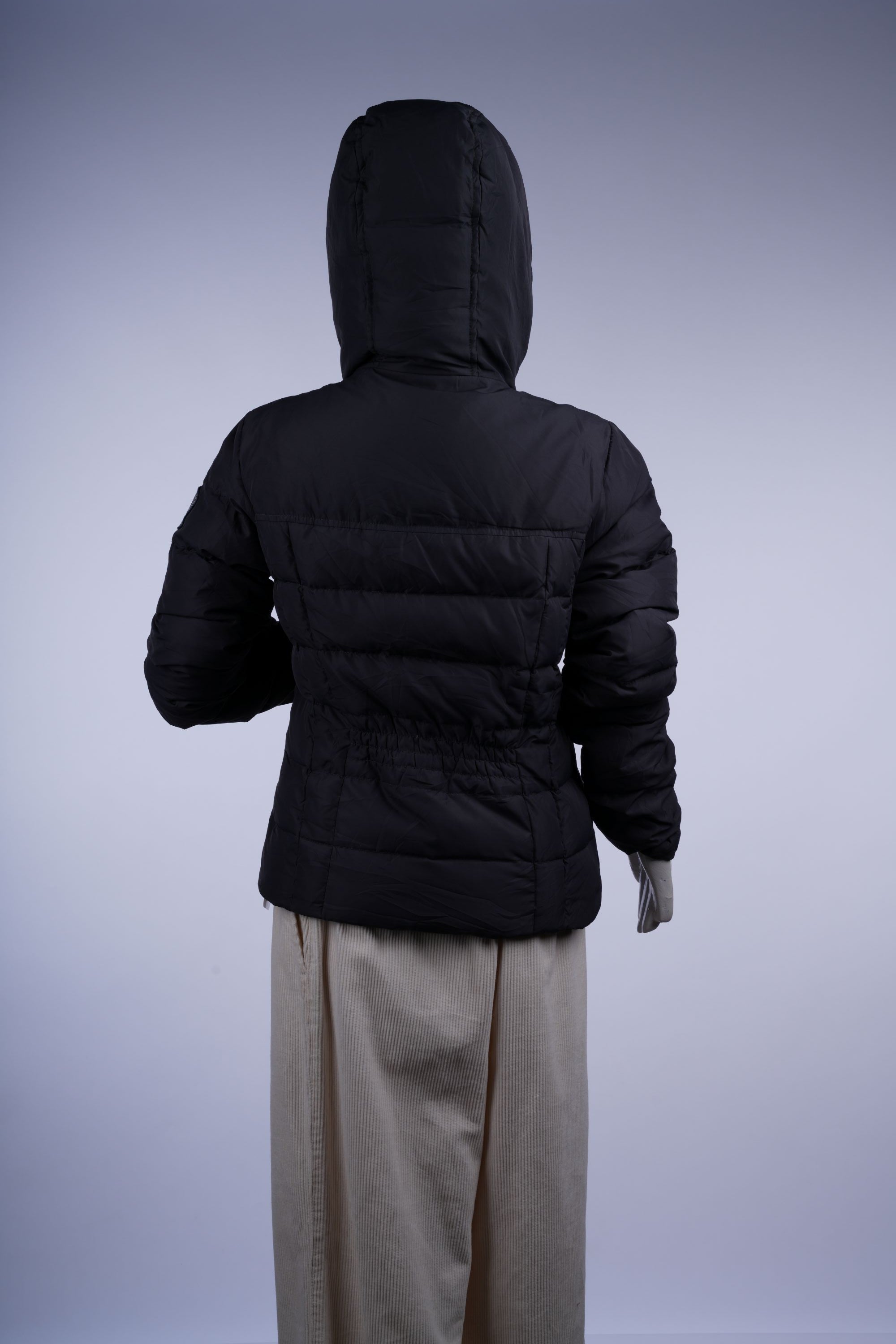 Weather-resistant dark grey and black puffer jacket with high collar and zip closure, perfect for versatile cold-weather style.