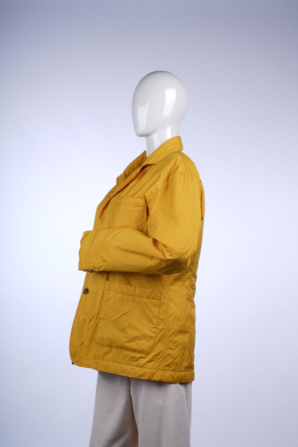 Casual mustard yellow jacket with button closure, multiple pockets, and classic collar, perfect for transitional seasons.