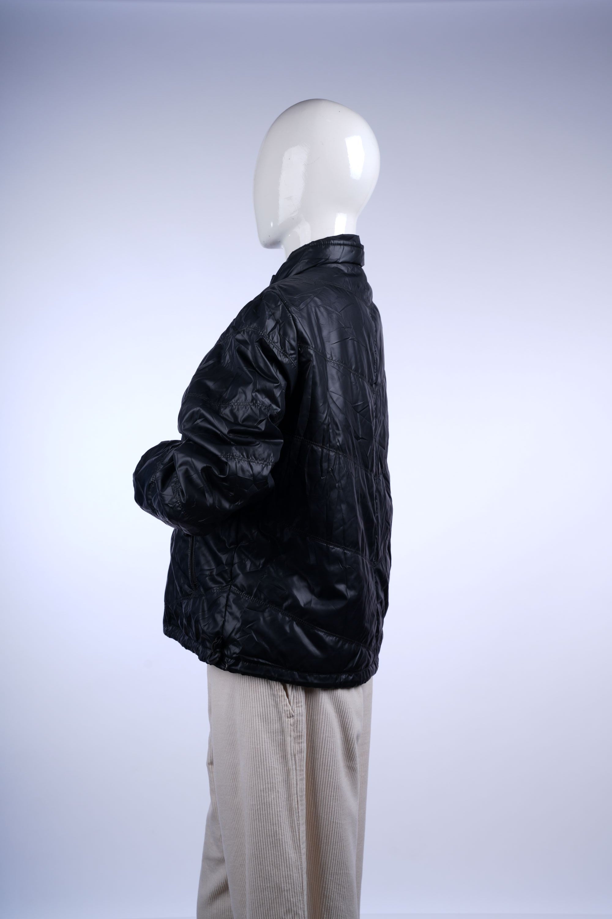 Insulated black puffer jacket with quilted design, stand-up collar, and secure zip pockets for versatile daily wear.