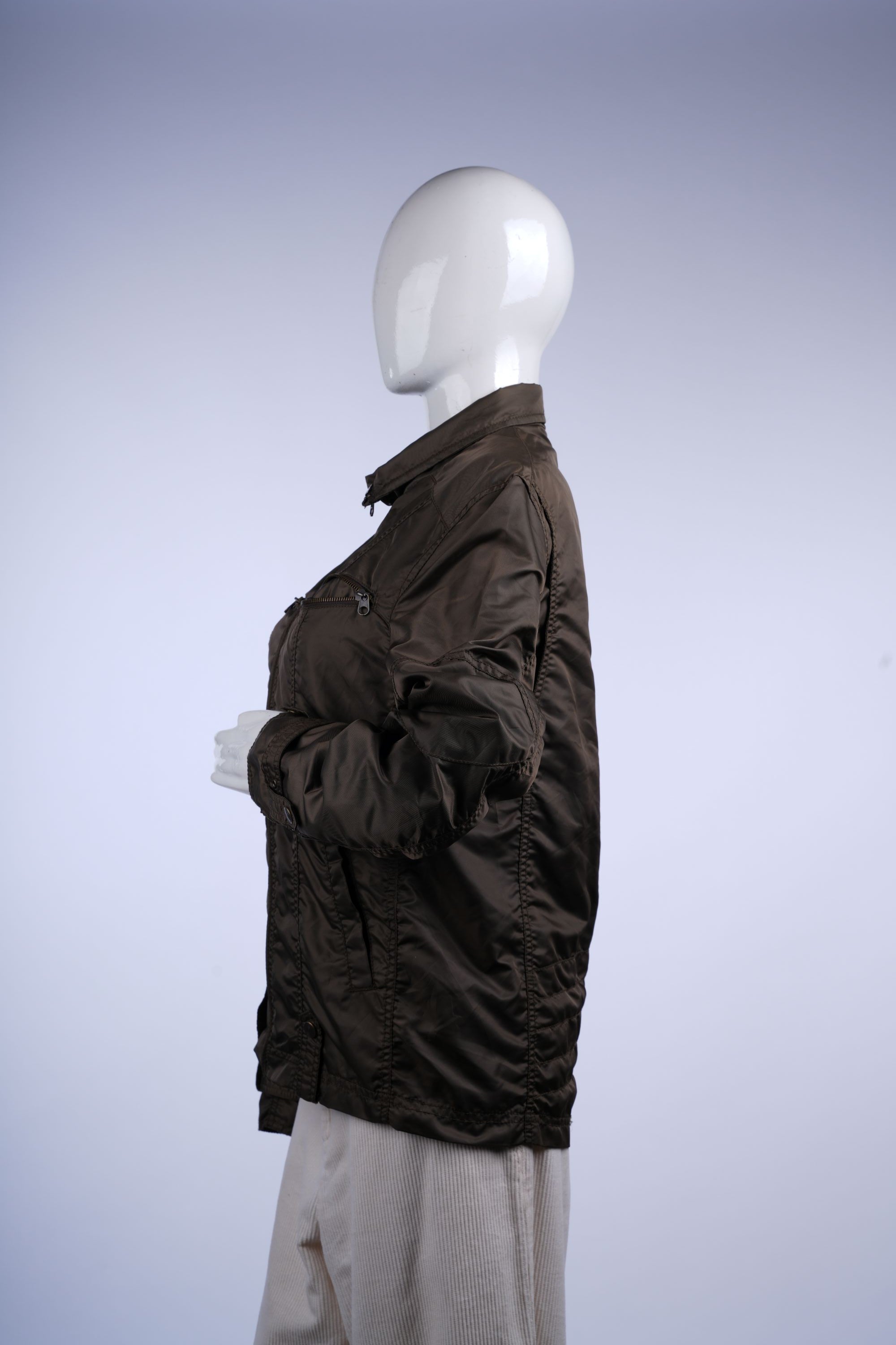 Transitional-season ruched jacket with zip front, functional pockets, and faux-fur lined collar for warmth and style.