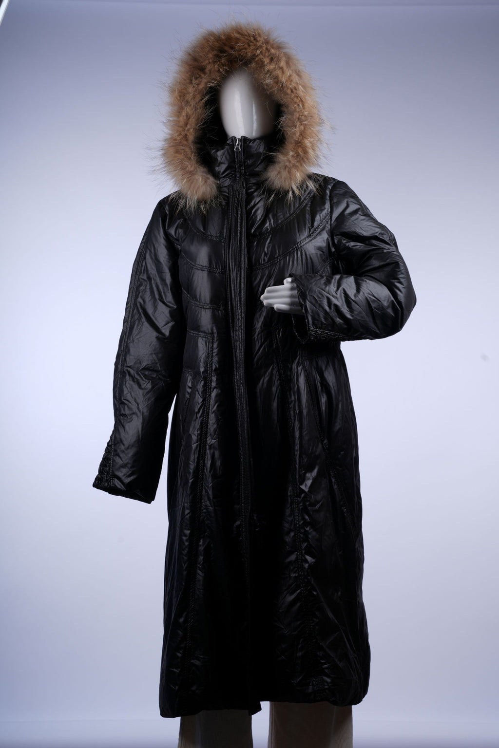 Warm black quilted puffer coat featuring a fur-trimmed hood, ideal for cold-weather fashion.
