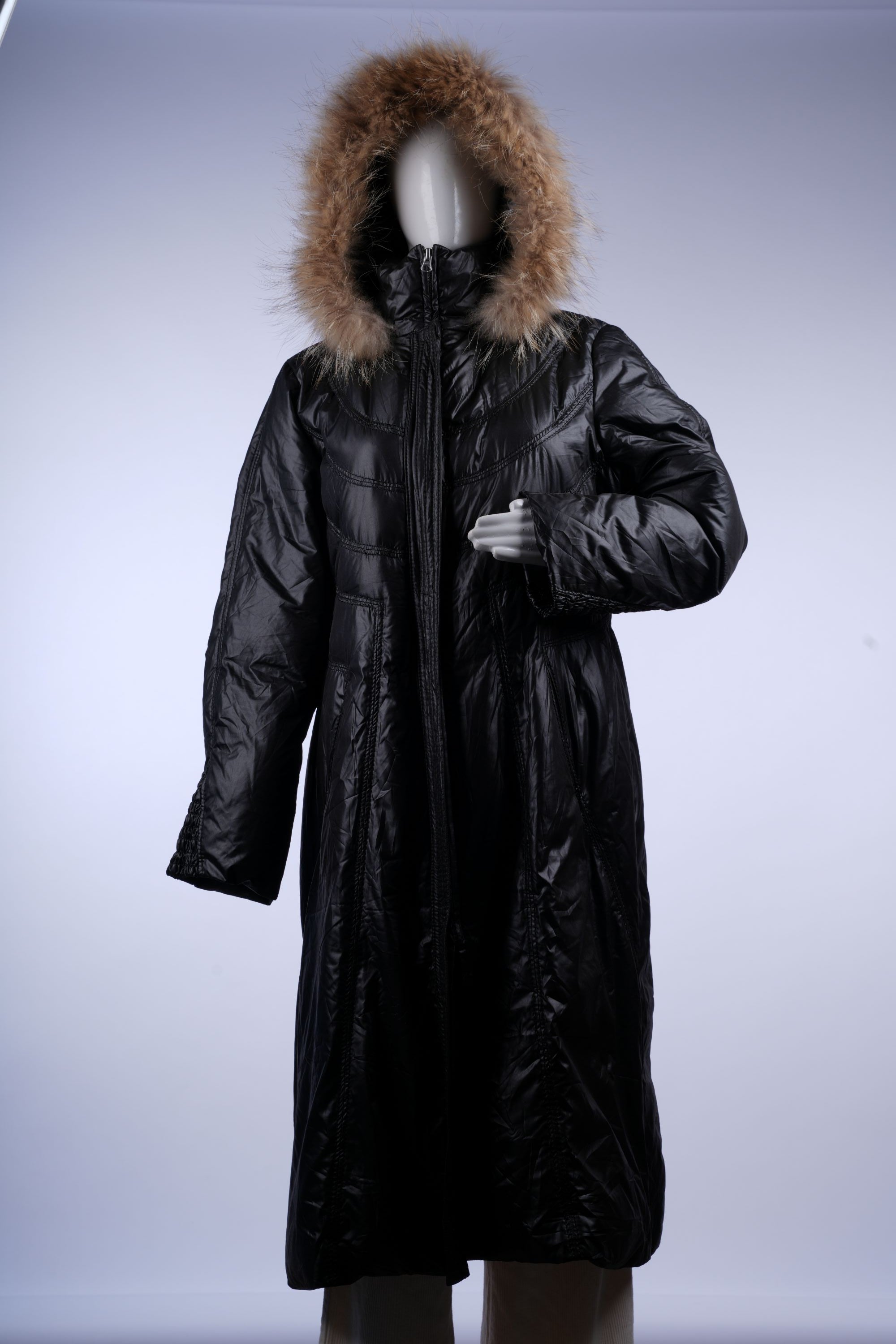 Warm black quilted puffer coat featuring a fur-trimmed hood, ideal for cold-weather fashion.