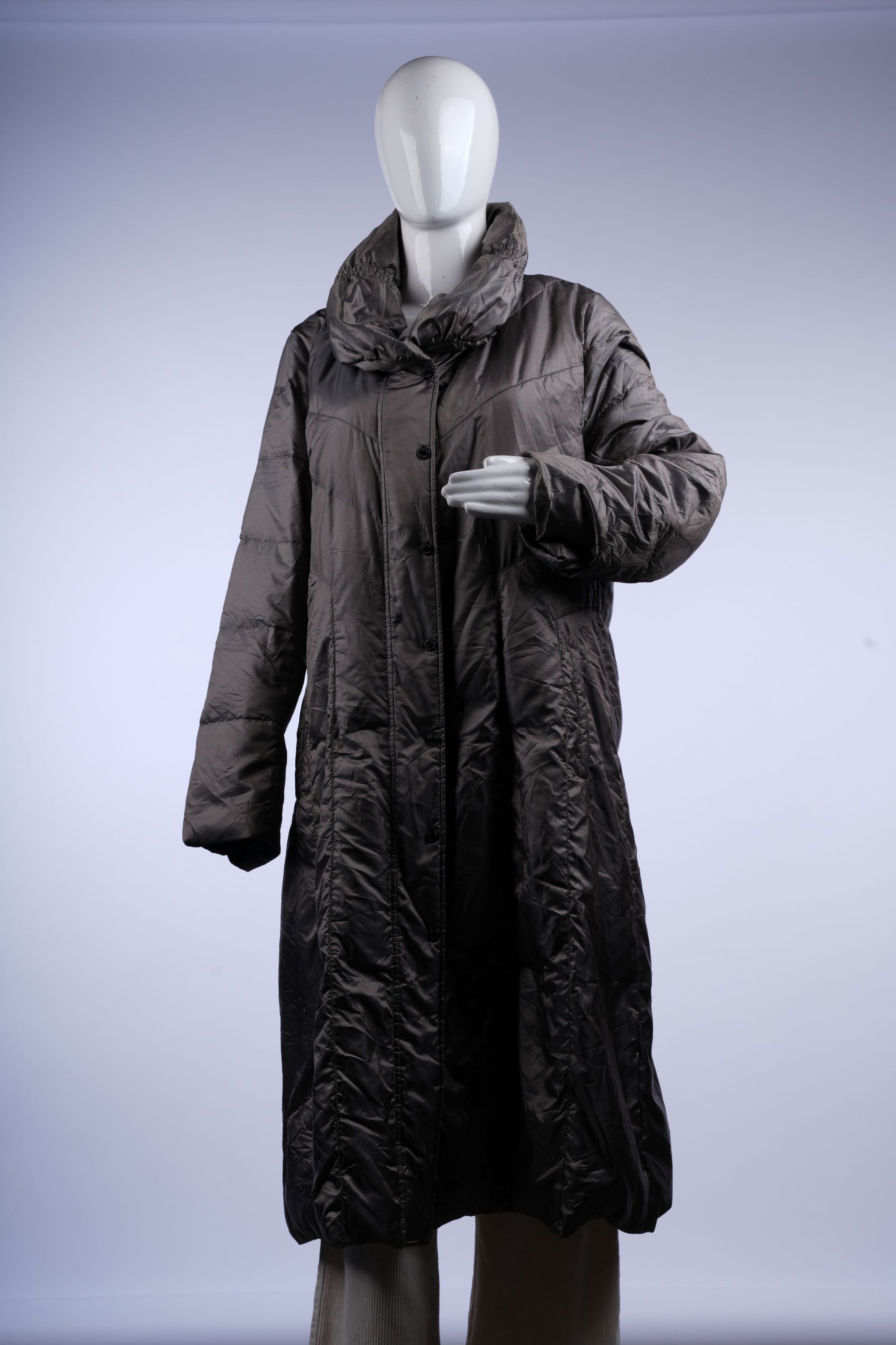 Sleek grey quilted puffer coat with stand-up collar and zip front, designed for stylish cold-weather layering.