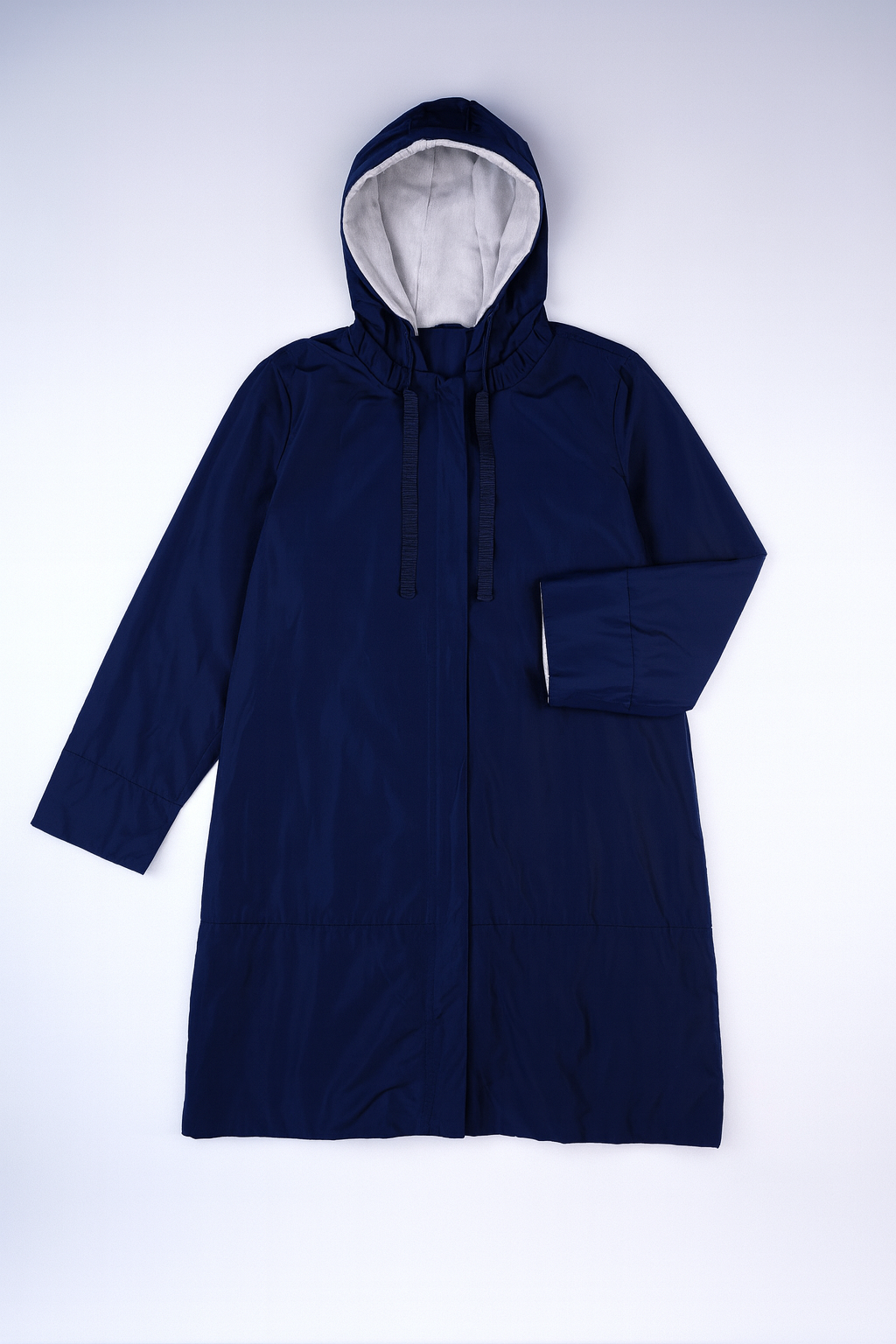Solid blue longline raincoat with attached hood, full-zip closure, and water-resistant fabric for wet-weather protection.