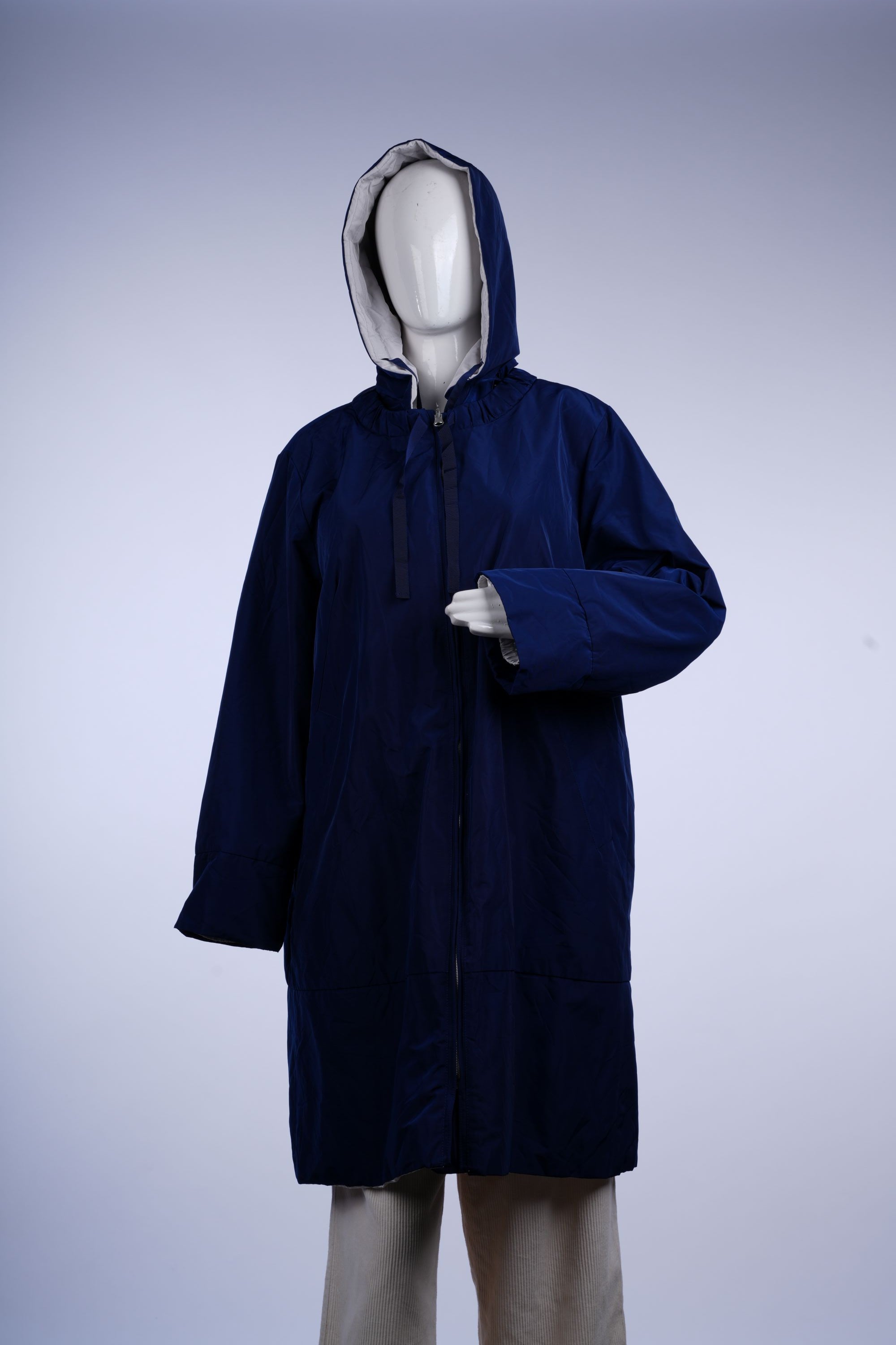 Practical blue raincoat featuring a hood, zip-front closure, and longline design, ideal for rainy days.