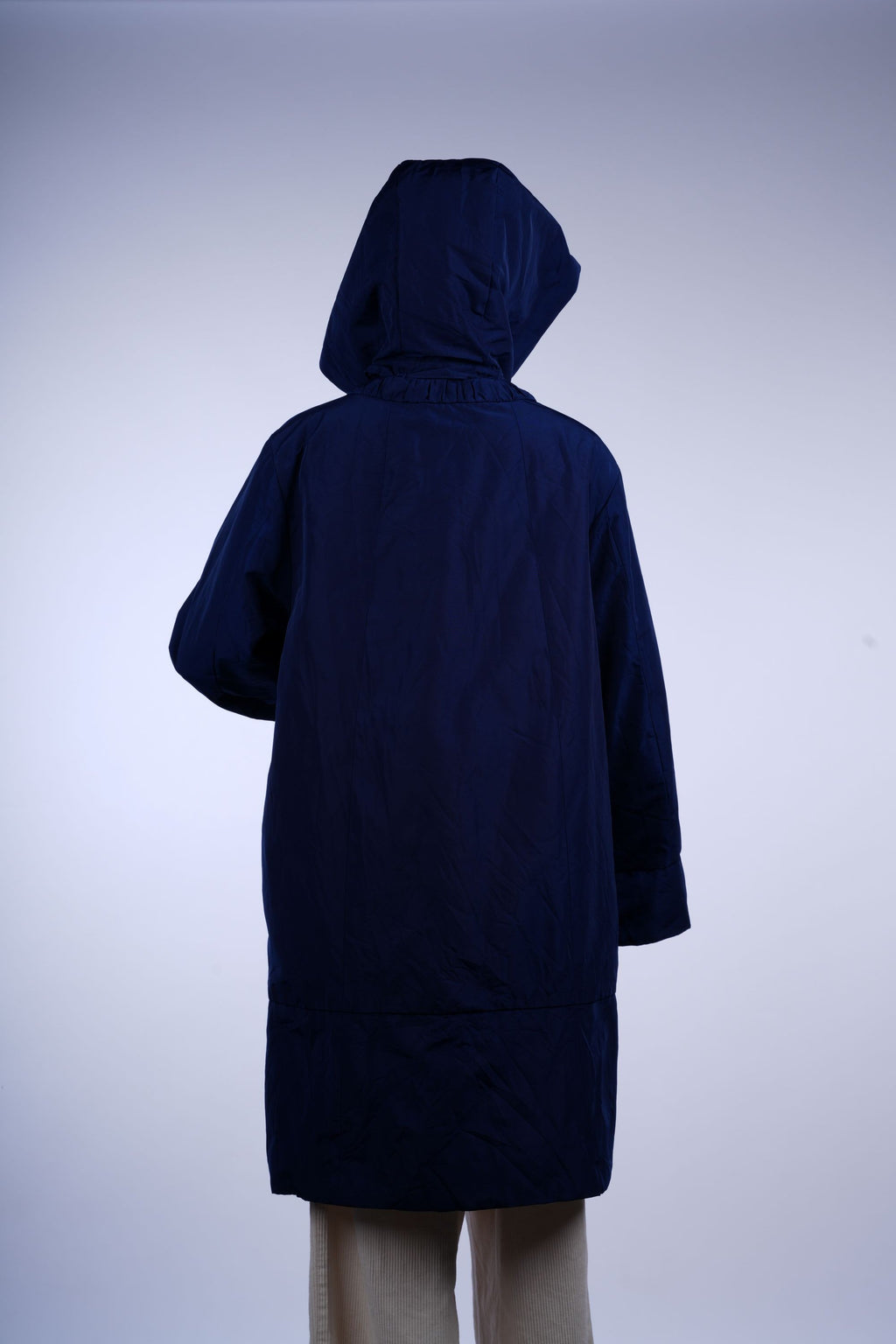 Sleek blue hooded raincoat with full-zip front and longline silhouette, perfect for staying dry in rain.
