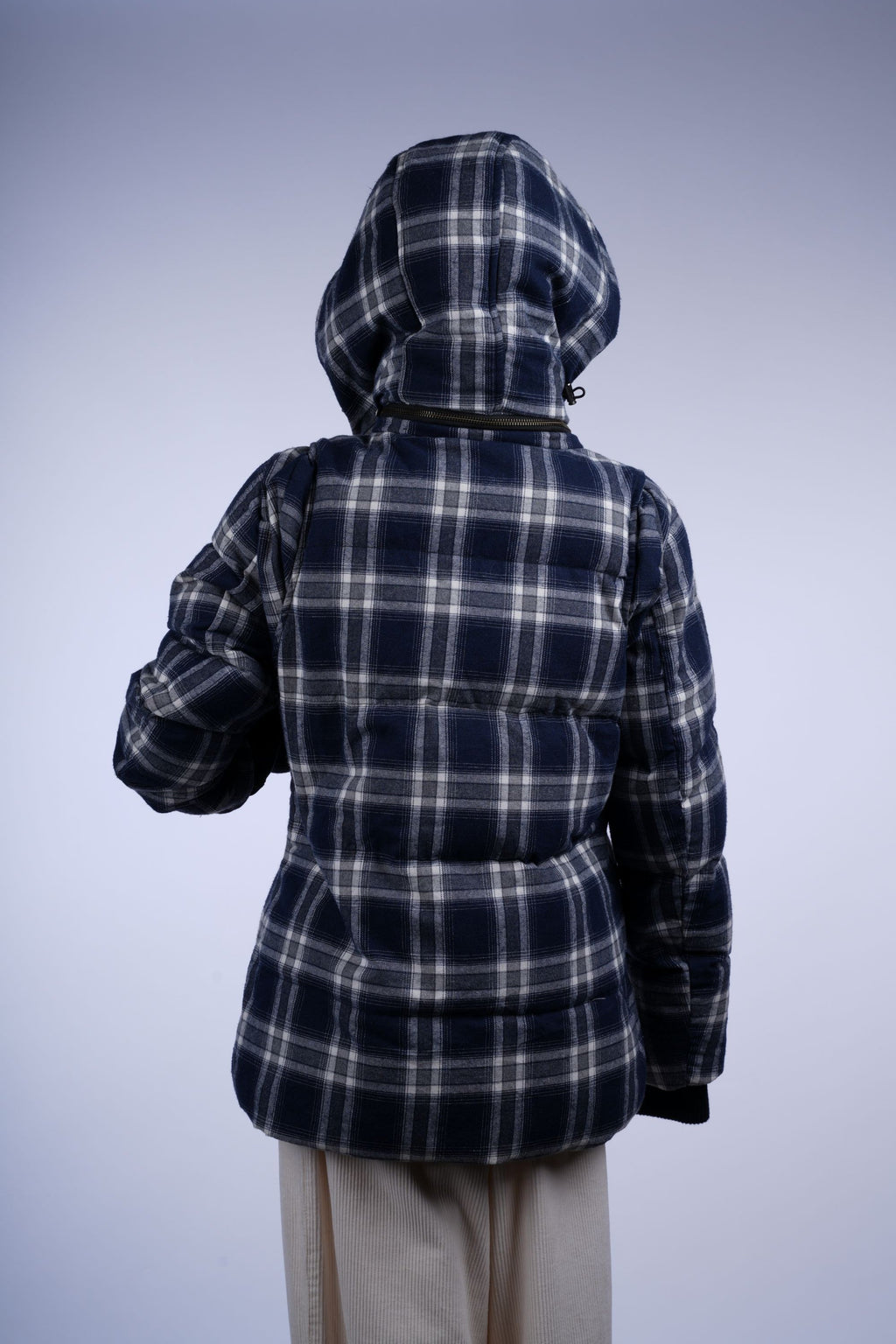 Warm plaid puffer jacket with hood, zip closure, and side pockets in blue-and-white tones, perfect for casual outings.