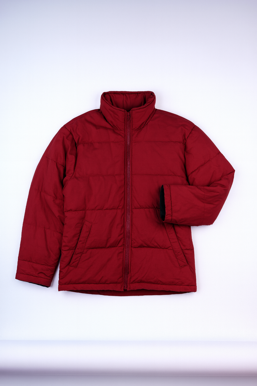 Deep red quilted puffer jacket with green-and-blue plaid lining, stand-up collar, full-zip front, and pockets for casual warmth.