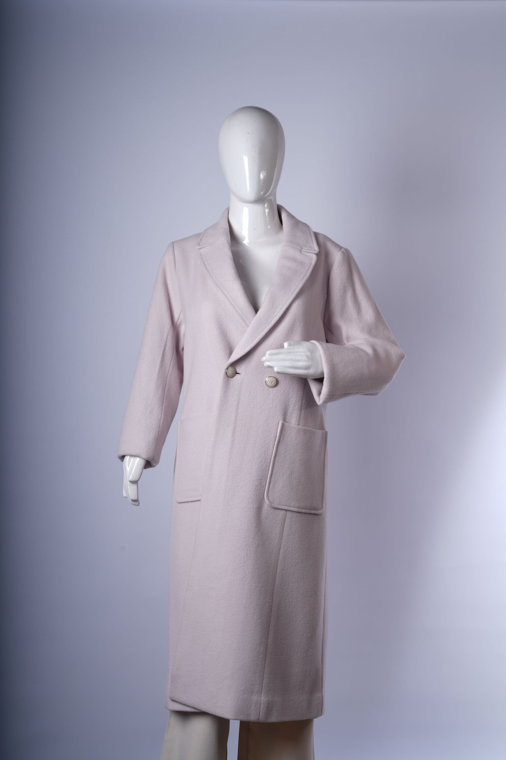 Tailored mid-length double-breasted coat in a soft neutral shade, featuring notched lapels and practical front pockets.