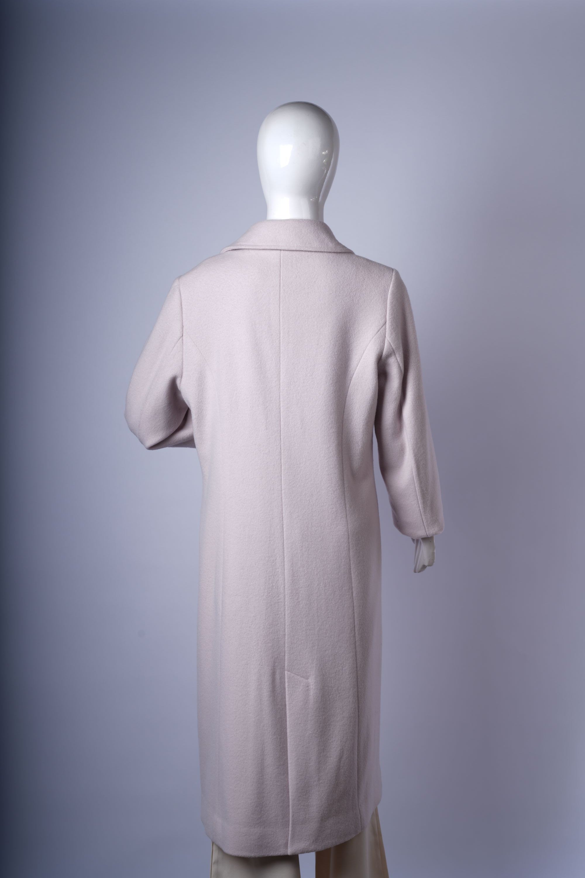 Sophisticated double-breasted coat in a light neutral tone with front pockets, tailored fit, and classic notched lapels.