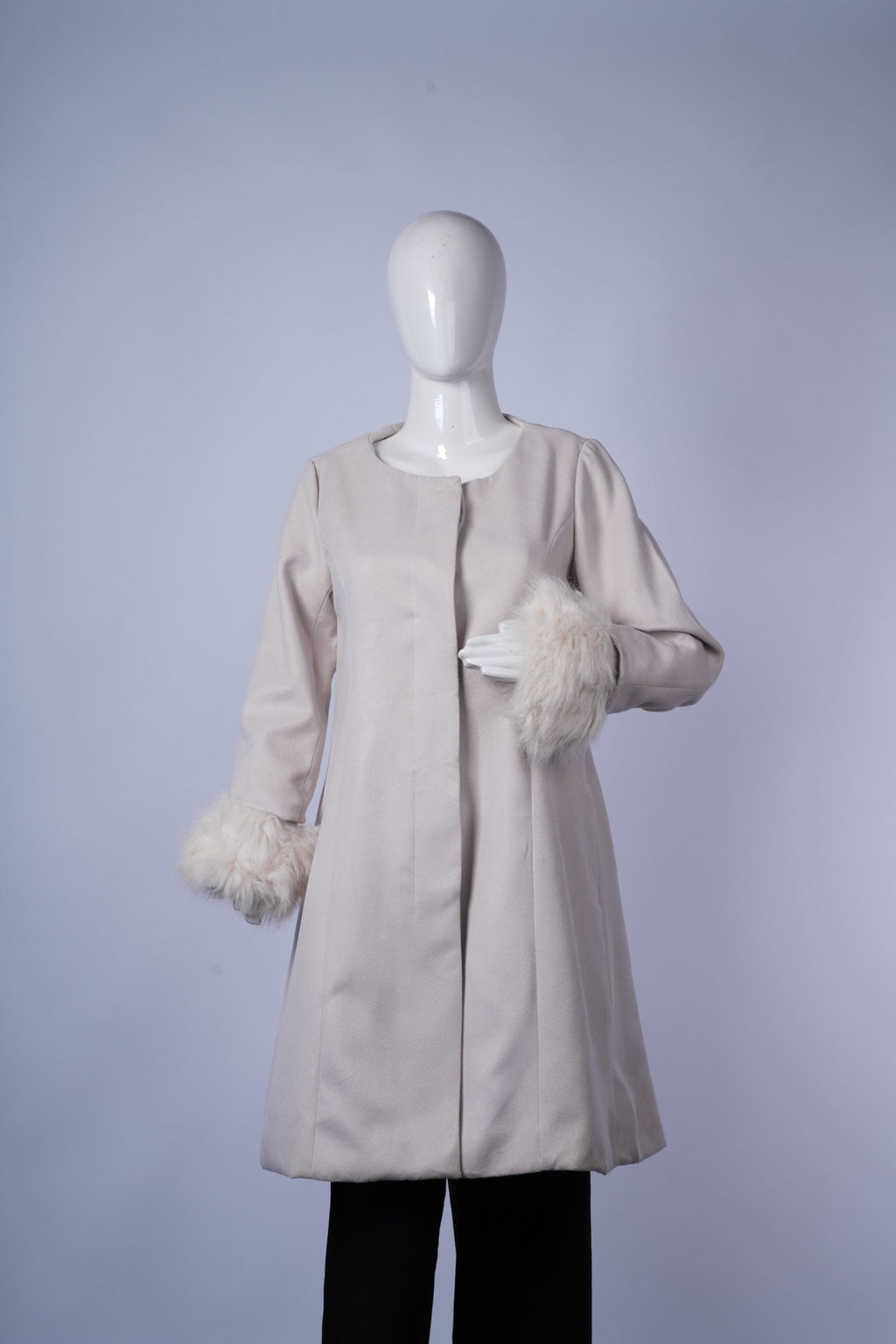 Refined off-white coat featuring faux fur-trimmed cuffs, round neckline, and a sleek concealed button front for semi-formal style.