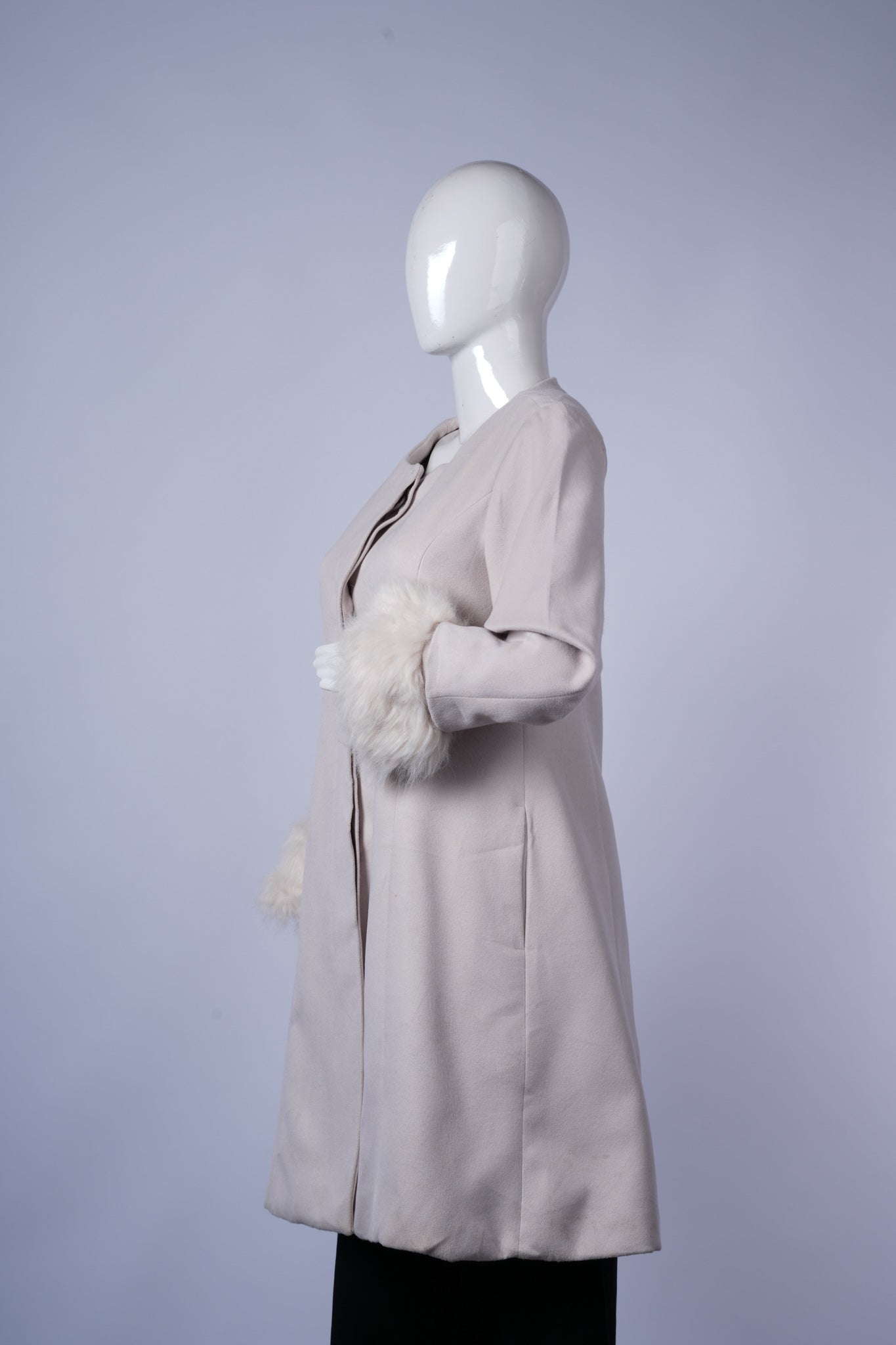 Elegant off-white wool-blend coat with cozy faux fur cuffs, tailored silhouette, and hidden buttons for polished layering.