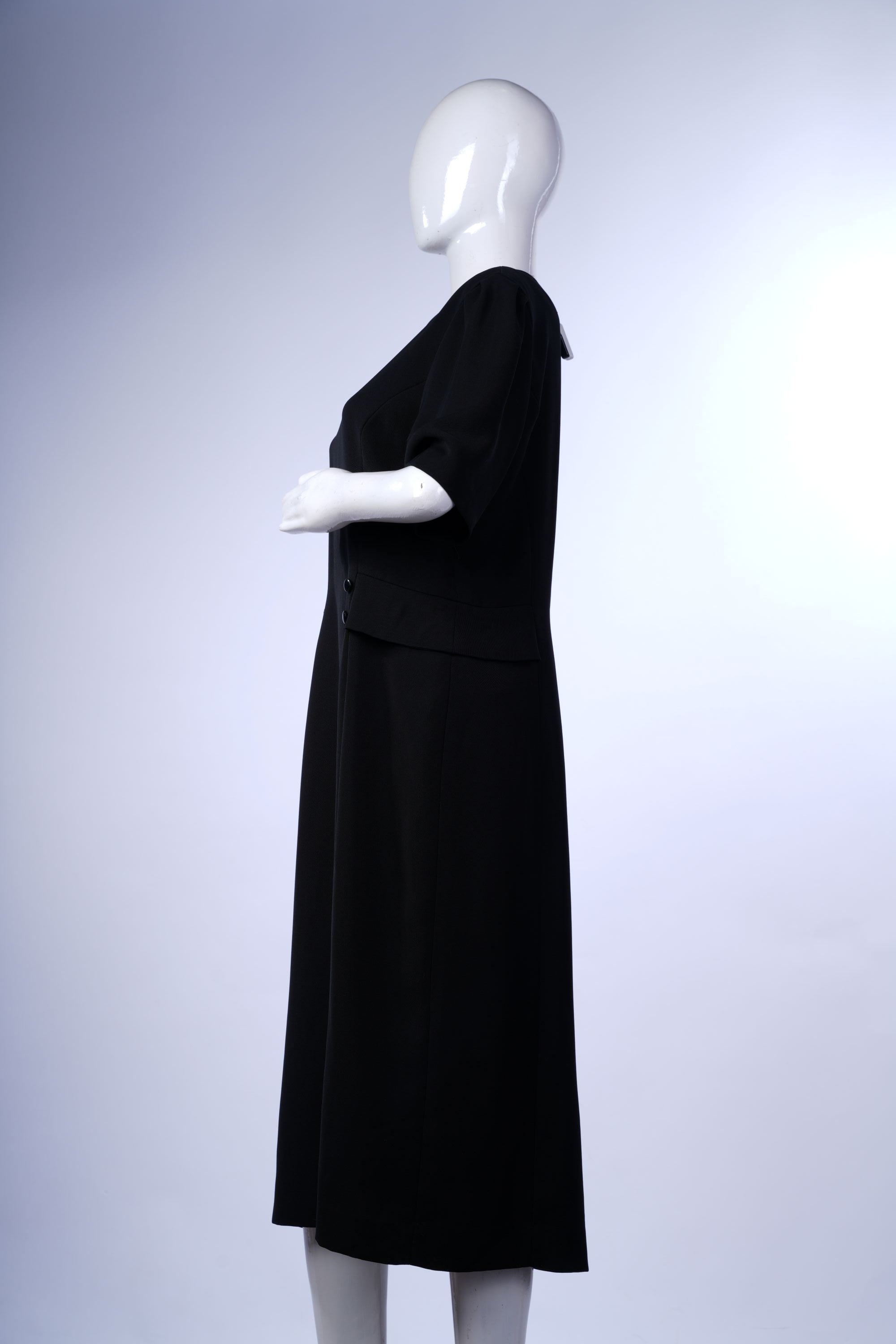 Sophisticated black midi dress with slit-front detail and long sleeves, suitable for formal or semi-formal wear.
