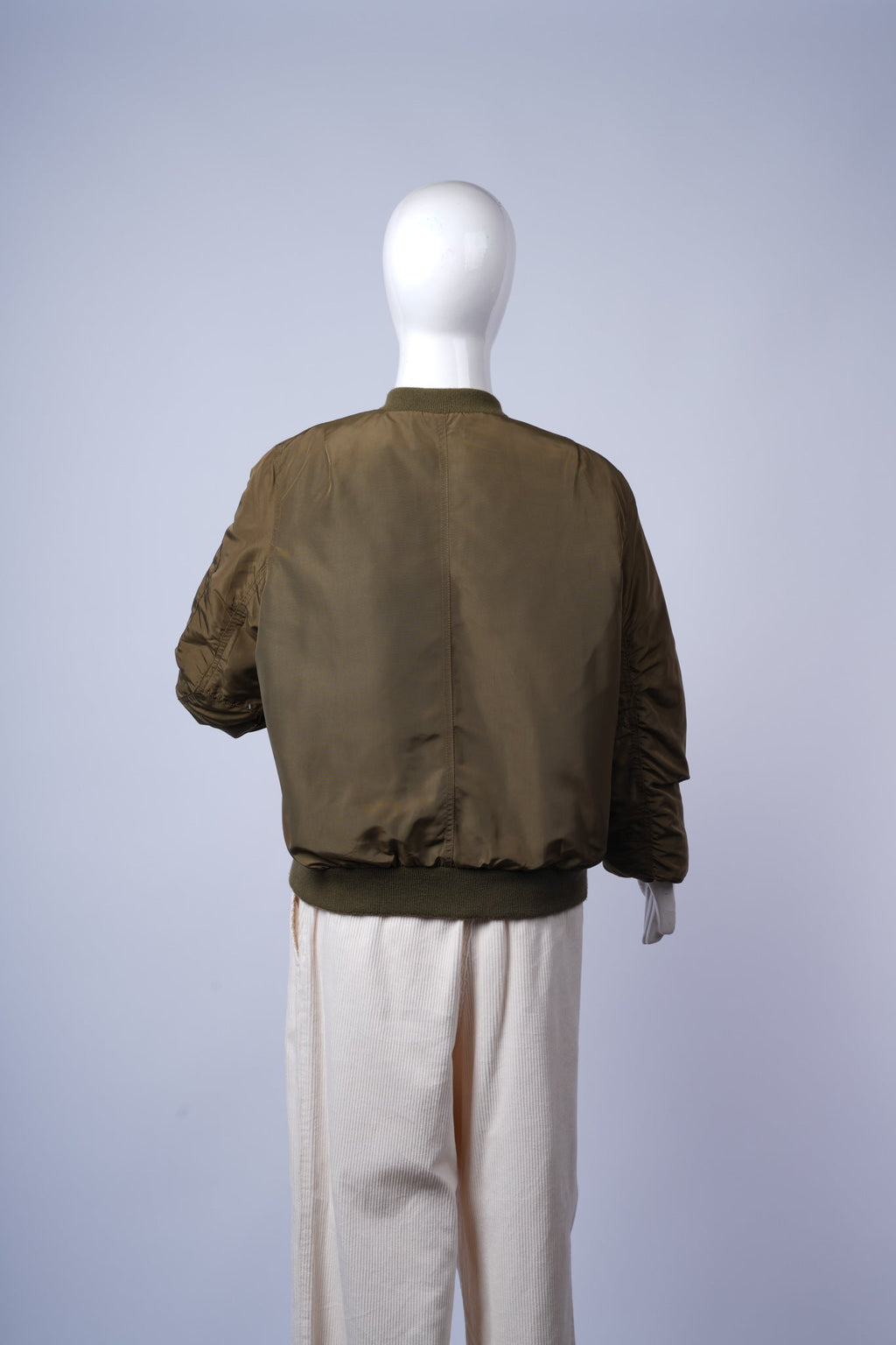 Versatile olive green puffer jacket for everyday wear with stylish bomber silhouette.