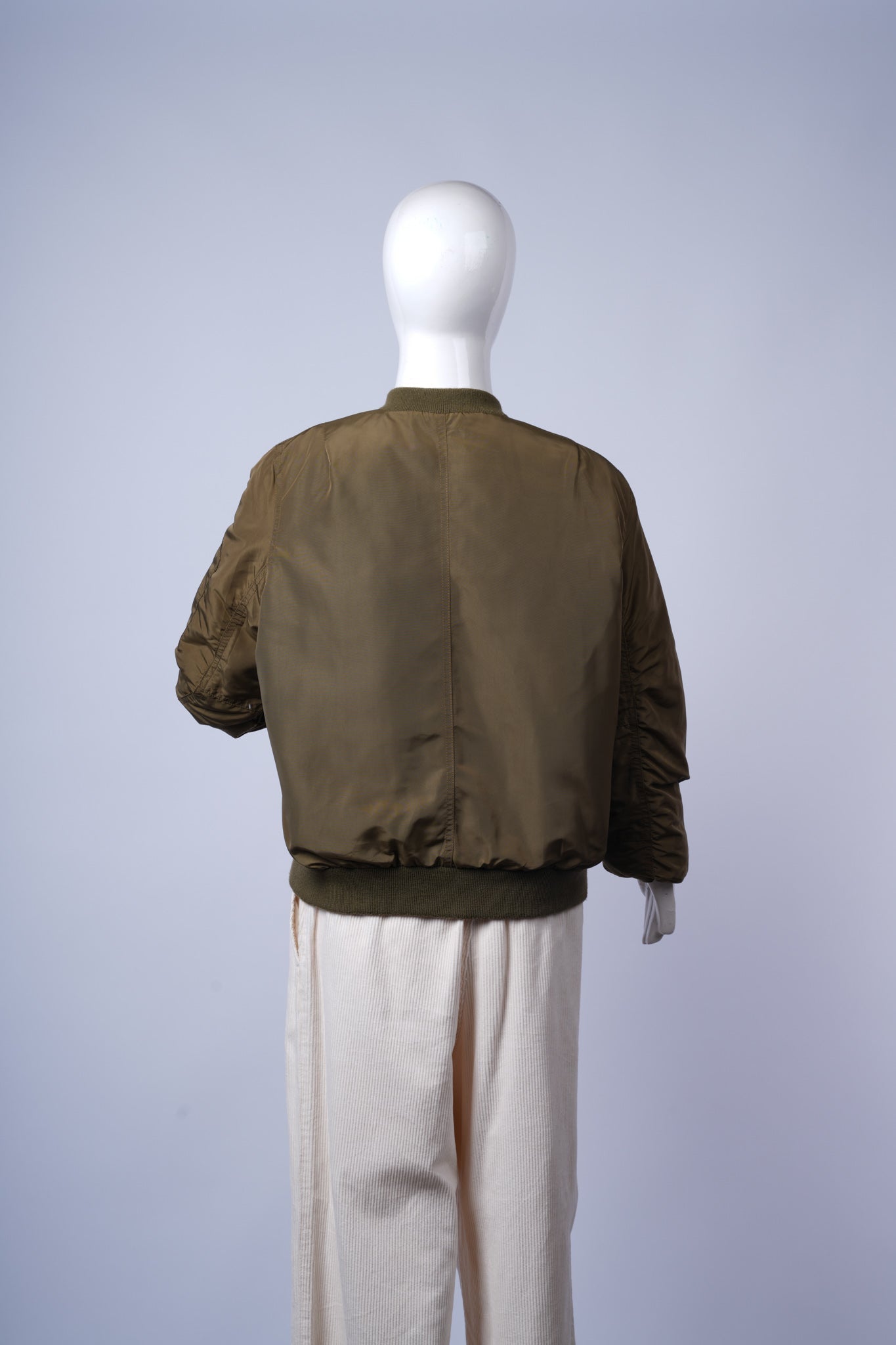 Versatile olive green puffer jacket for everyday wear with stylish bomber silhouette.