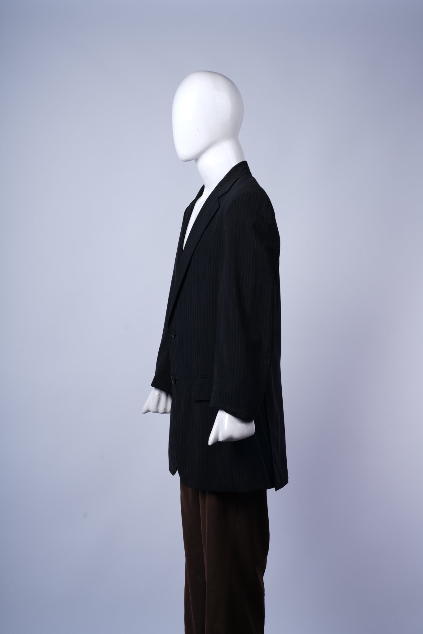 Elegant dark pinstriped blazer with flap pockets, ideal for formal business wear.