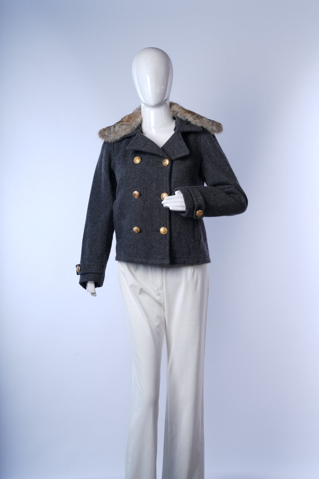 Elegant gray peacoat featuring structured design, plush fur collar, and decorative buttons.