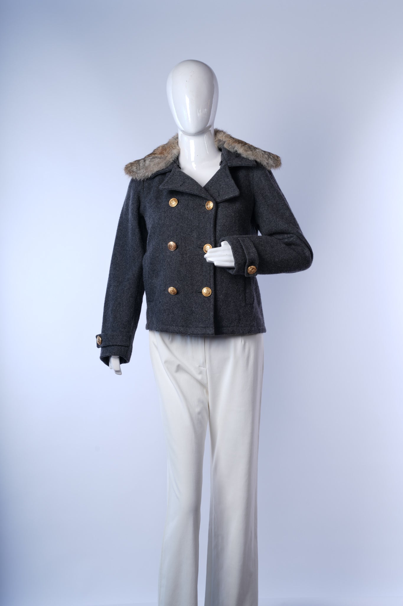 Elegant gray peacoat featuring structured design, plush fur collar, and decorative buttons.