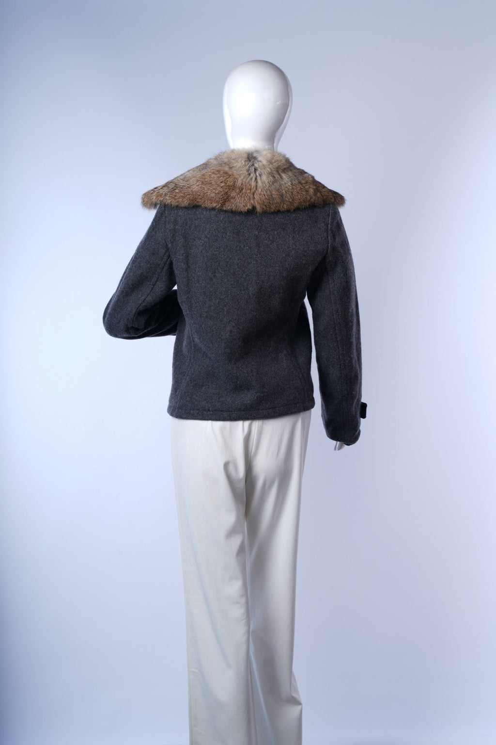 Structured double-breasted coat in gray with fur trim and gold accents, perfect for winter.