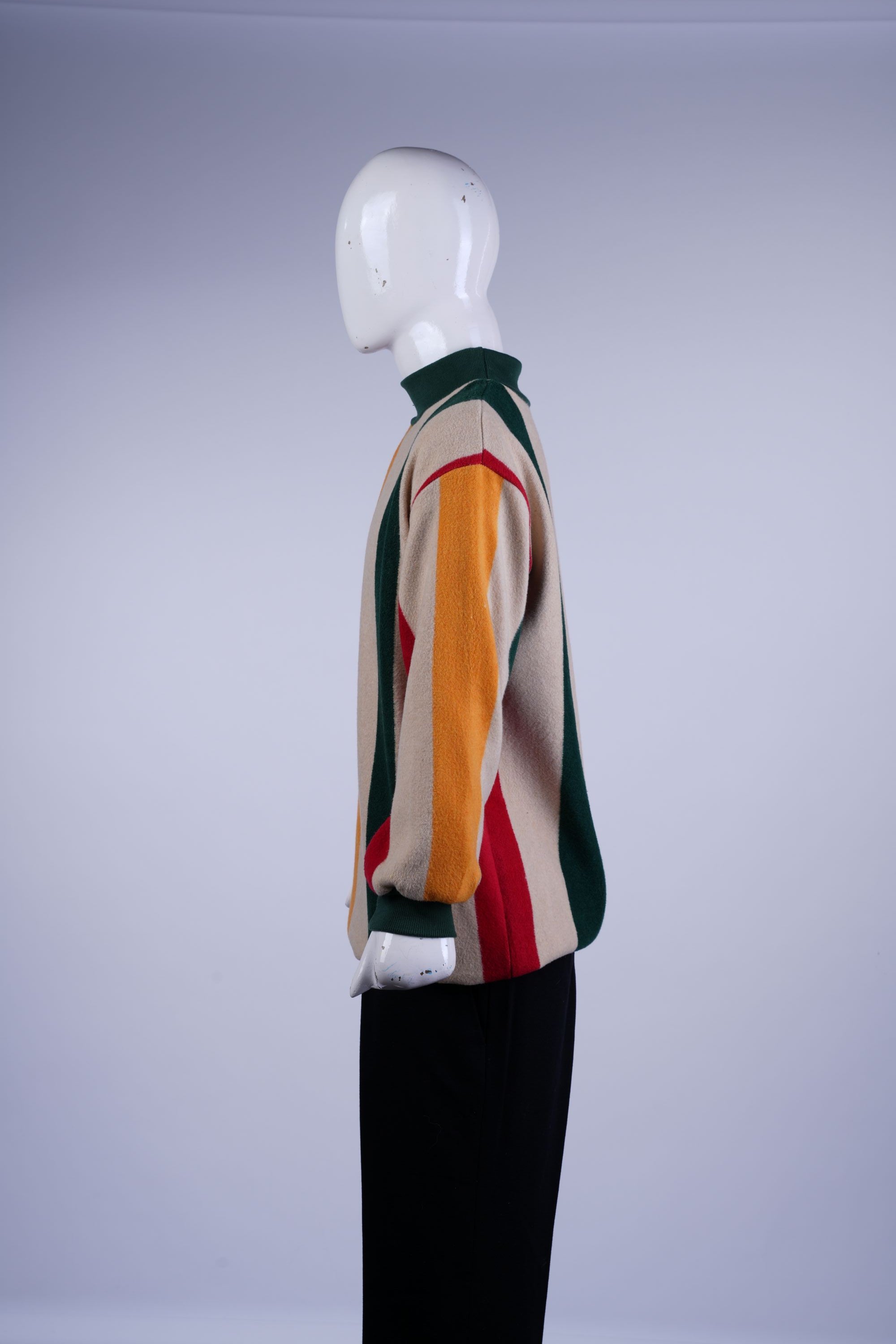 Colorful Lele striped sweater with a mock neck, perfect for stylish layering and bold fashion statements.