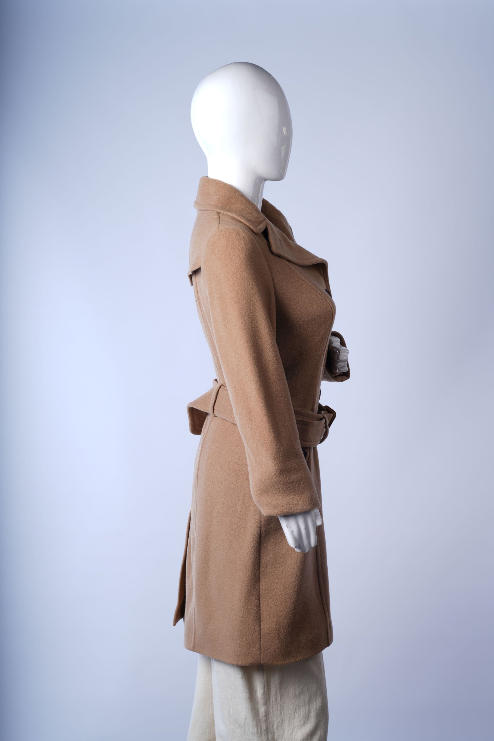 Timeless camel coat with belted cuffs and structured design for sophisticated winter wear.