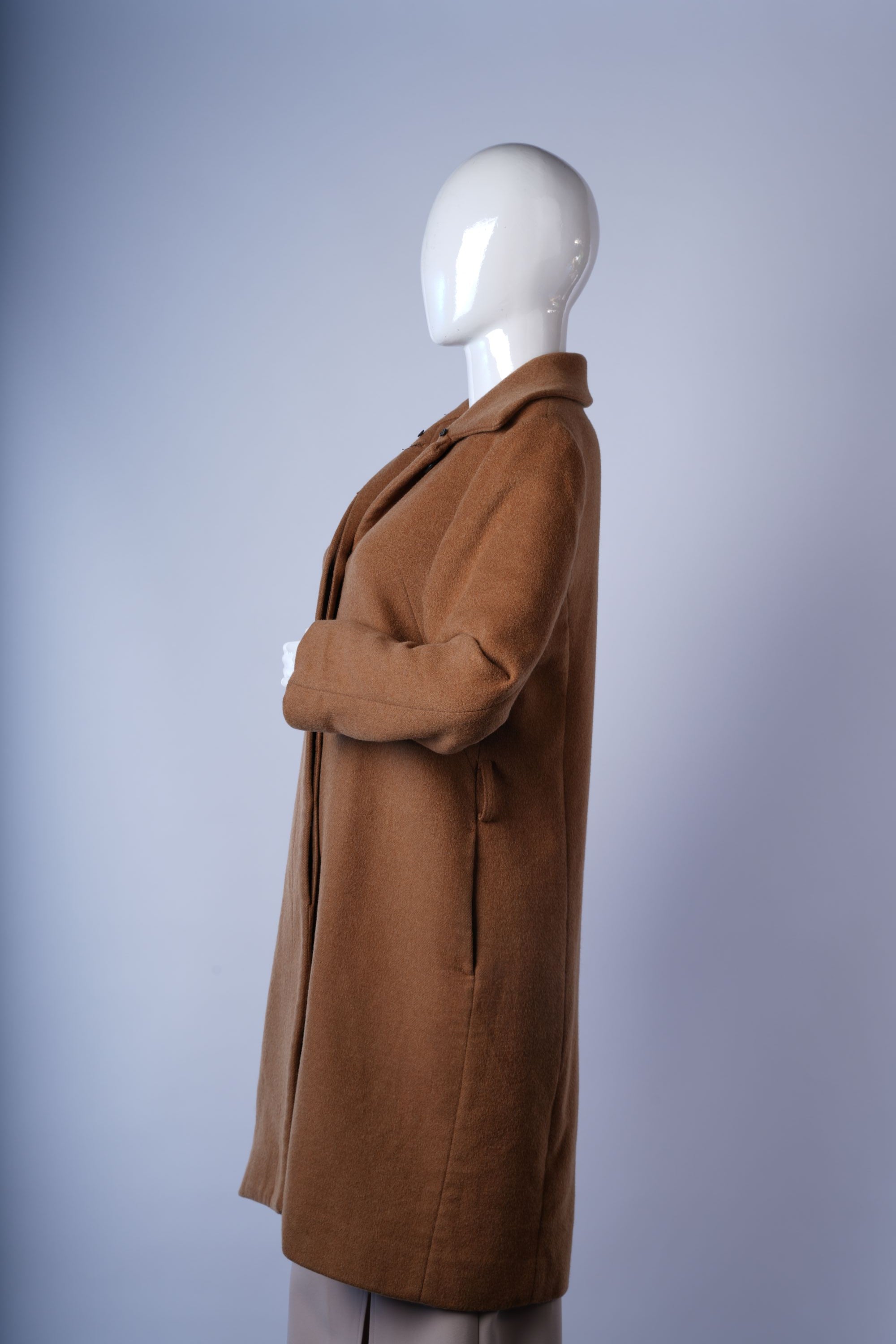 Oversized beige faux-fur coat with plush fabric and stylish front closure.
