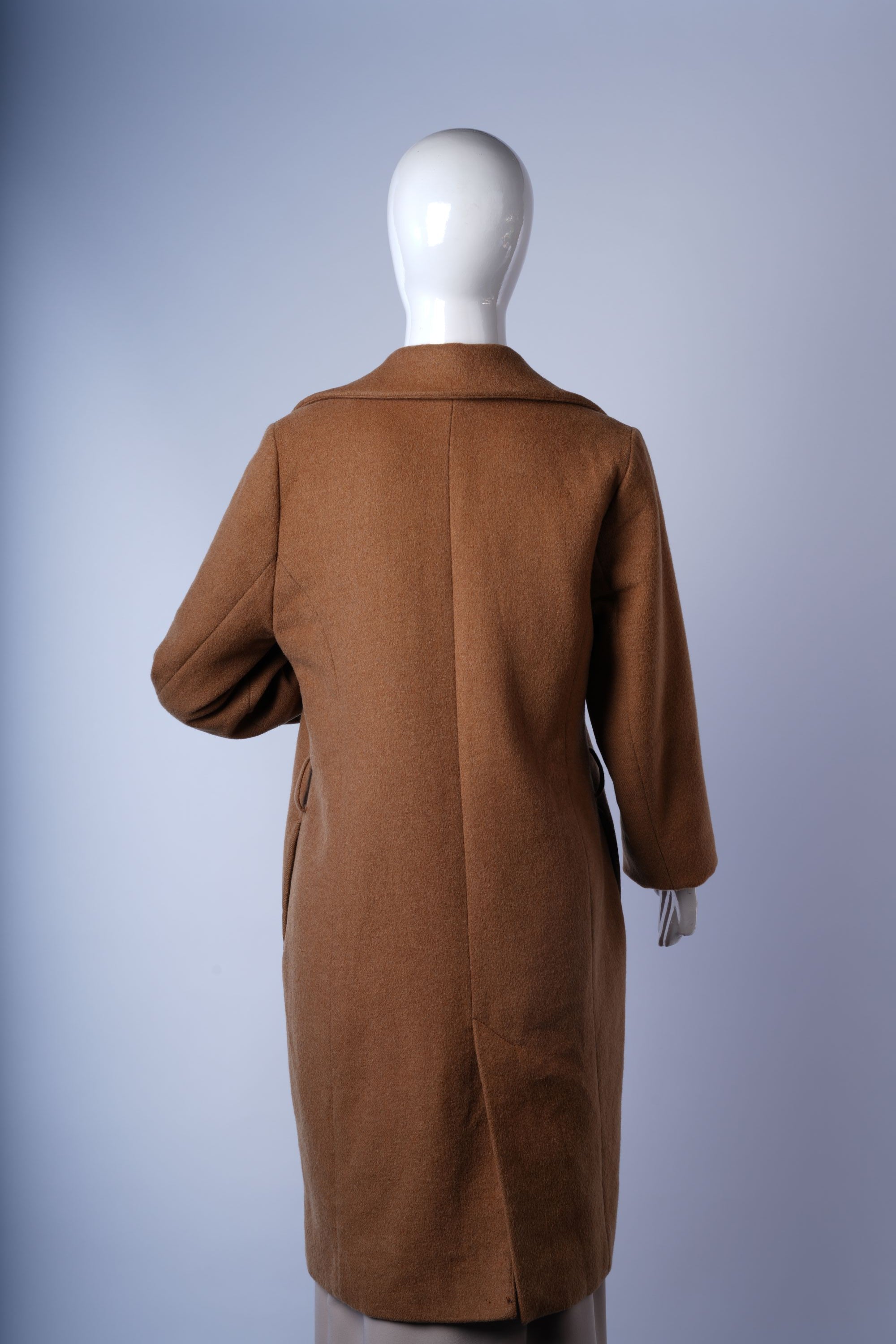 Soft textured faux-fur coat in beige, perfect for warm and fashionable winter outfits.