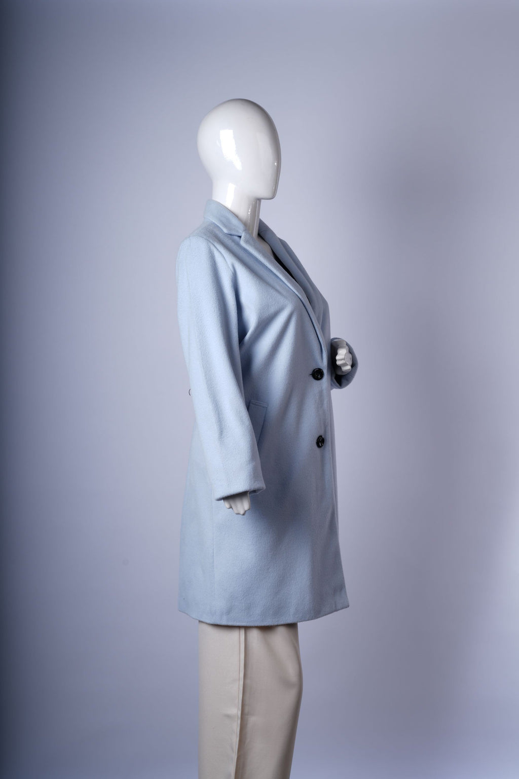 Pastel blue women's coat with classic single-breasted front, tailored notched lapels, and cozy mid-thigh length.