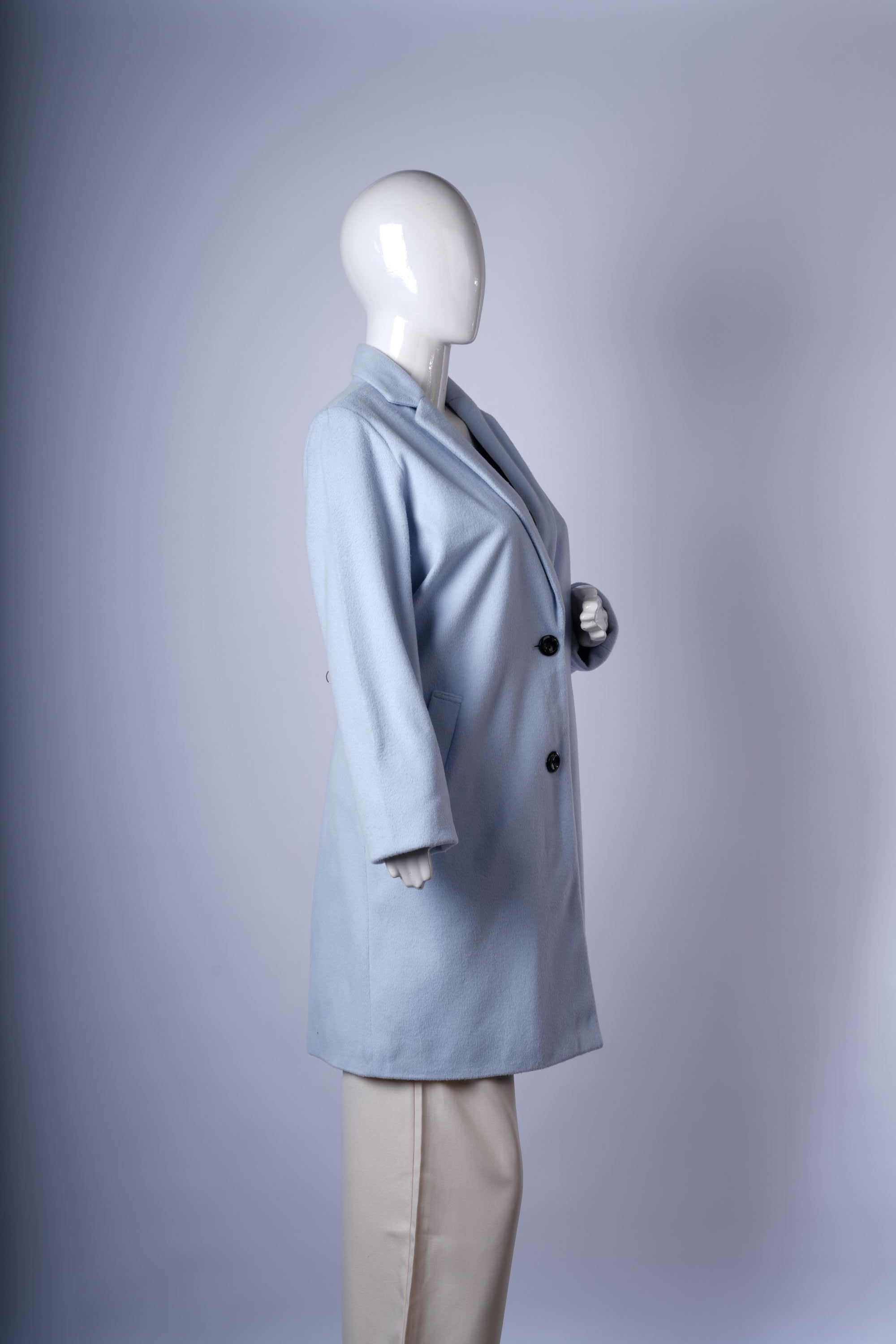 Pastel blue women's coat with classic single-breasted front, tailored notched lapels, and cozy mid-thigh length.