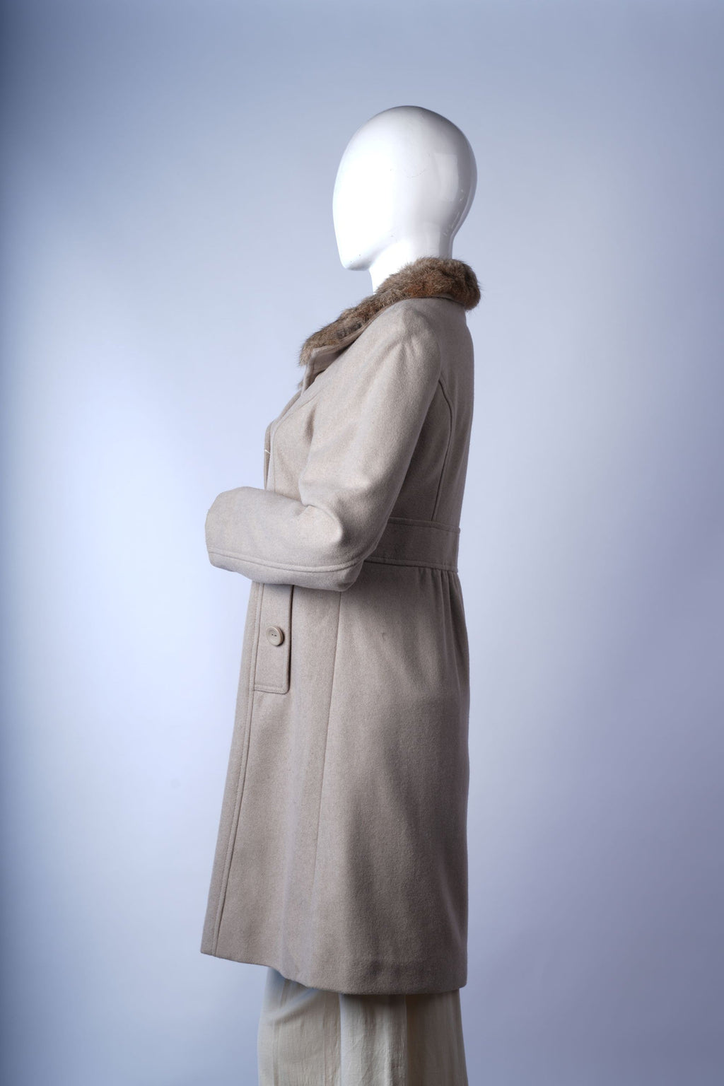 Quilted longline winter coat with detachable hood and secure front zipper.