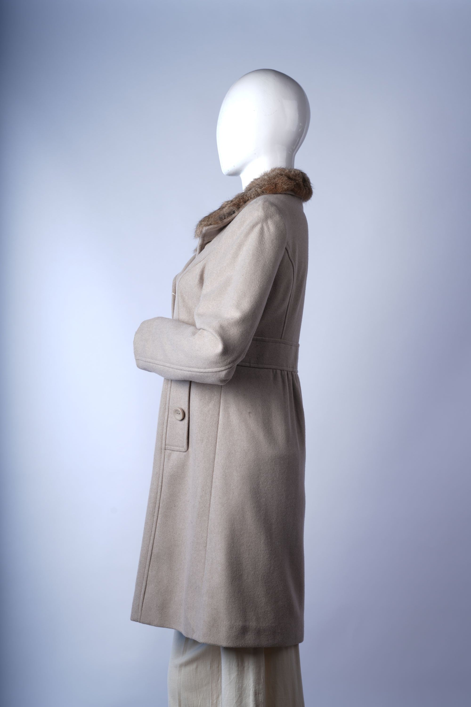 Quilted longline winter coat with detachable hood and secure front zipper.