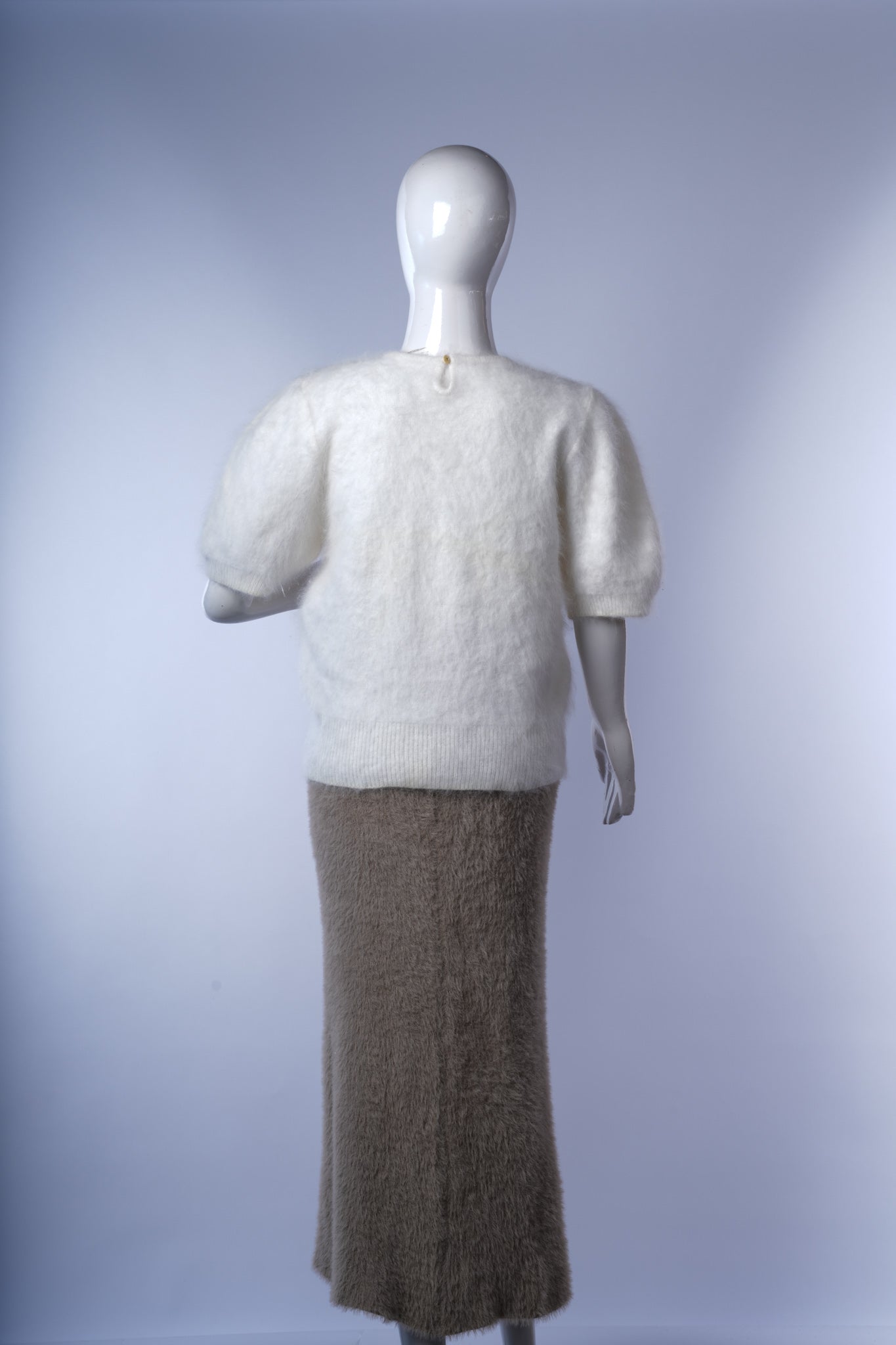  White embellished neckline sweater offering cozy comfort with refined style.