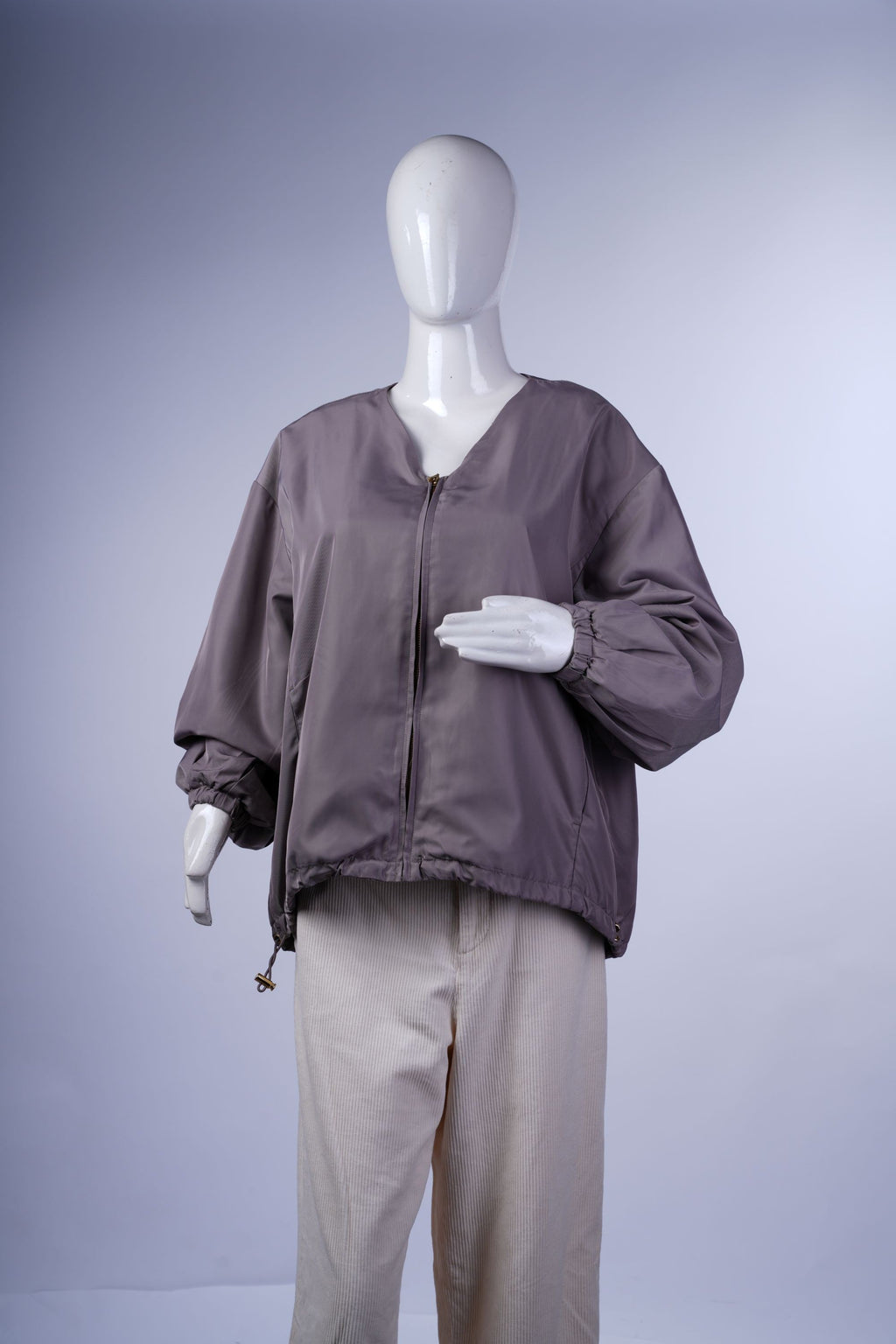 Lightweight, versatile jacket featuring a clean design, zip front, and practical side pockets for smart-casual wear.