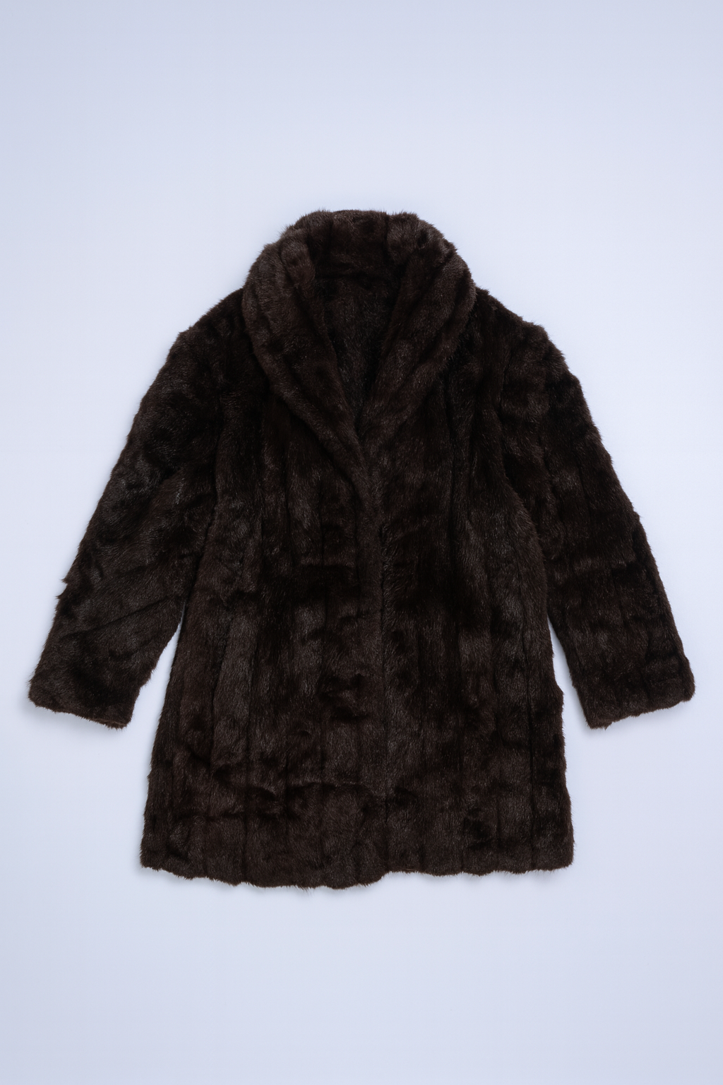 Luxurious dark brown faux-fur jacket with wide shawl collar and relaxed vintage fit.