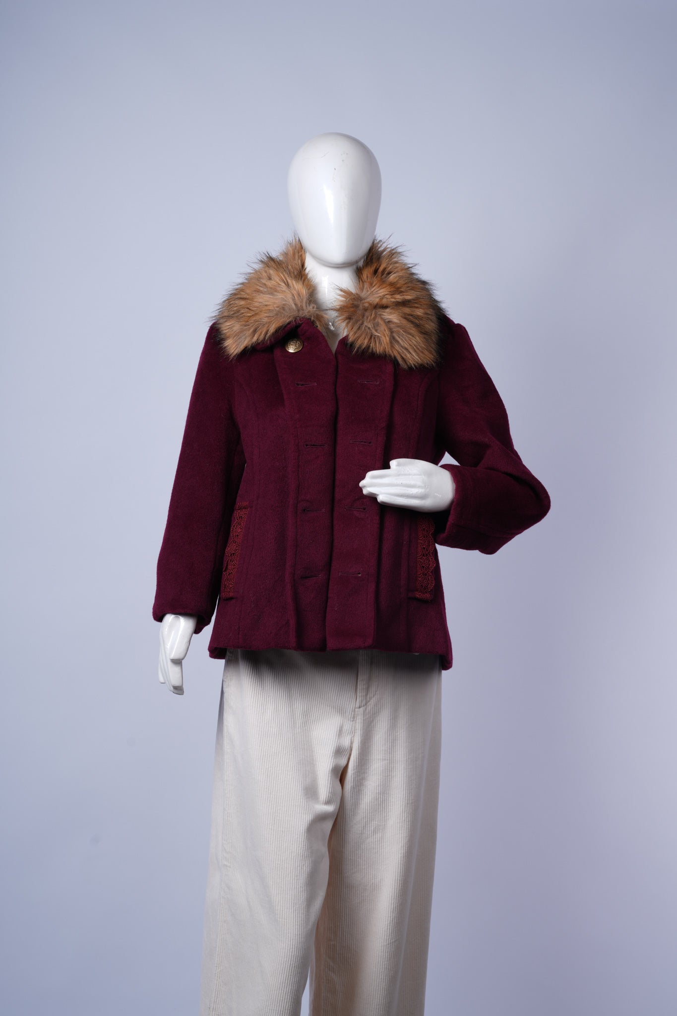 women's maroon winter coat featuring stylish fur collar and decorative lace pockets.