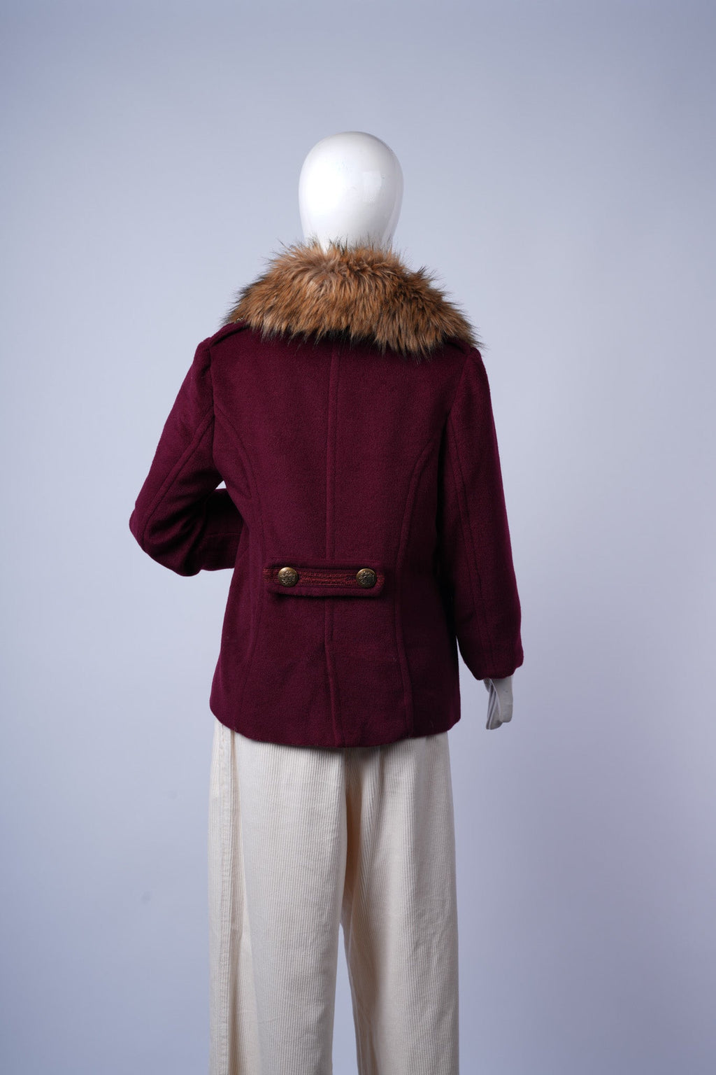 Stylish maroon coat with wide faux fur trim and lace-accented pockets, perfect for winter layering.