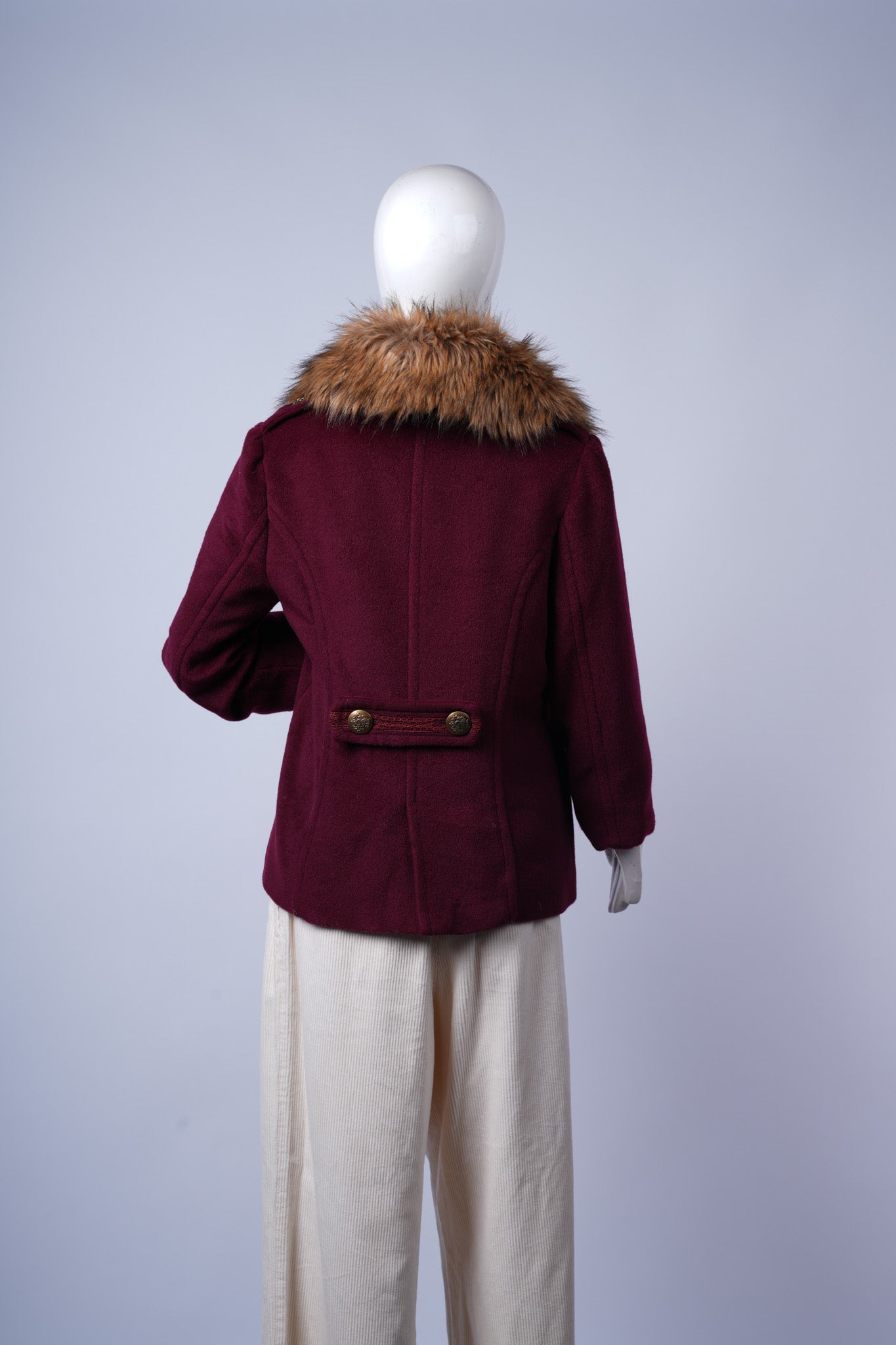 Stylish maroon coat with wide faux fur trim and lace-accented pockets, perfect for winter layering.