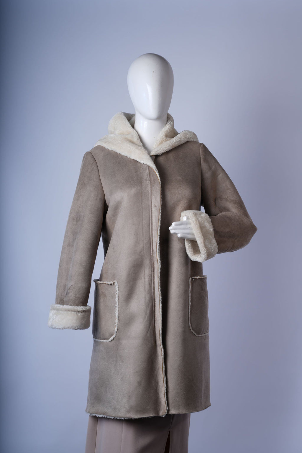 women's winter jacket featuring patch pockets, faux fur trim, and warm beige design.