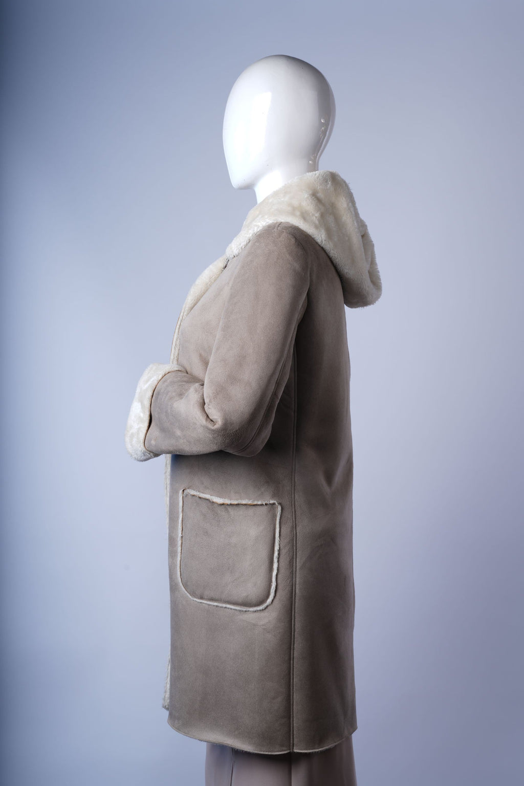 Stylish faux mouton jacket with hood and zip closure, perfect for cold-weather layering.