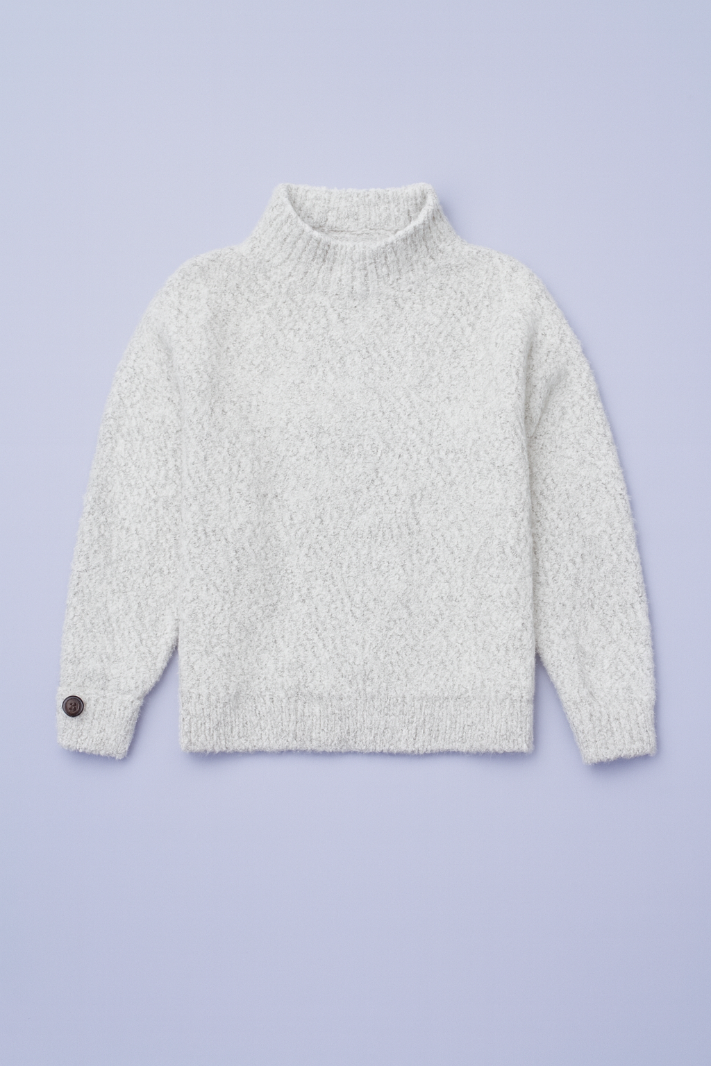 women's white textured knit sweater flat lay on pastel background