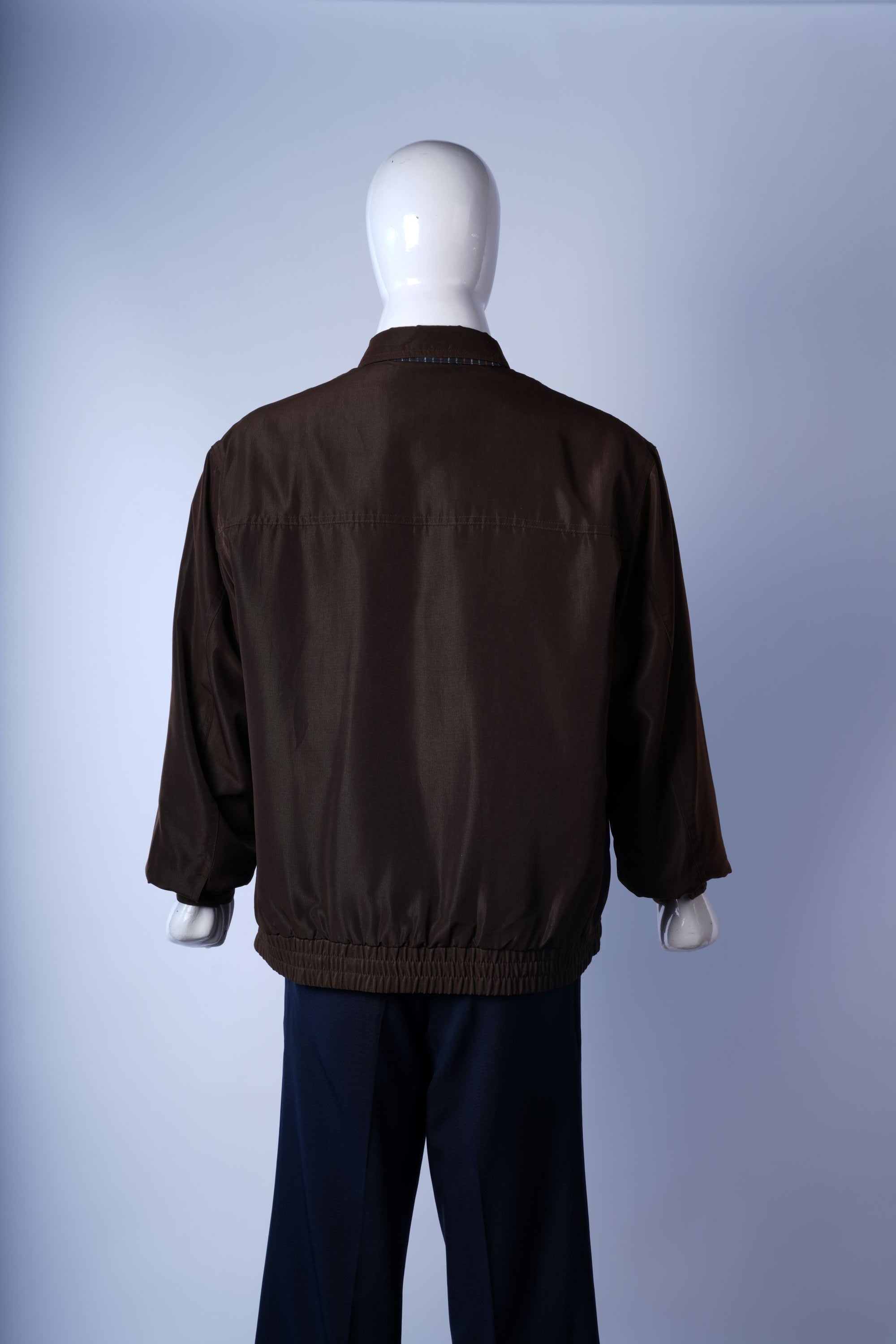 Versatile brown bomber with full zipper and plaid detail, perfect for casual layering.