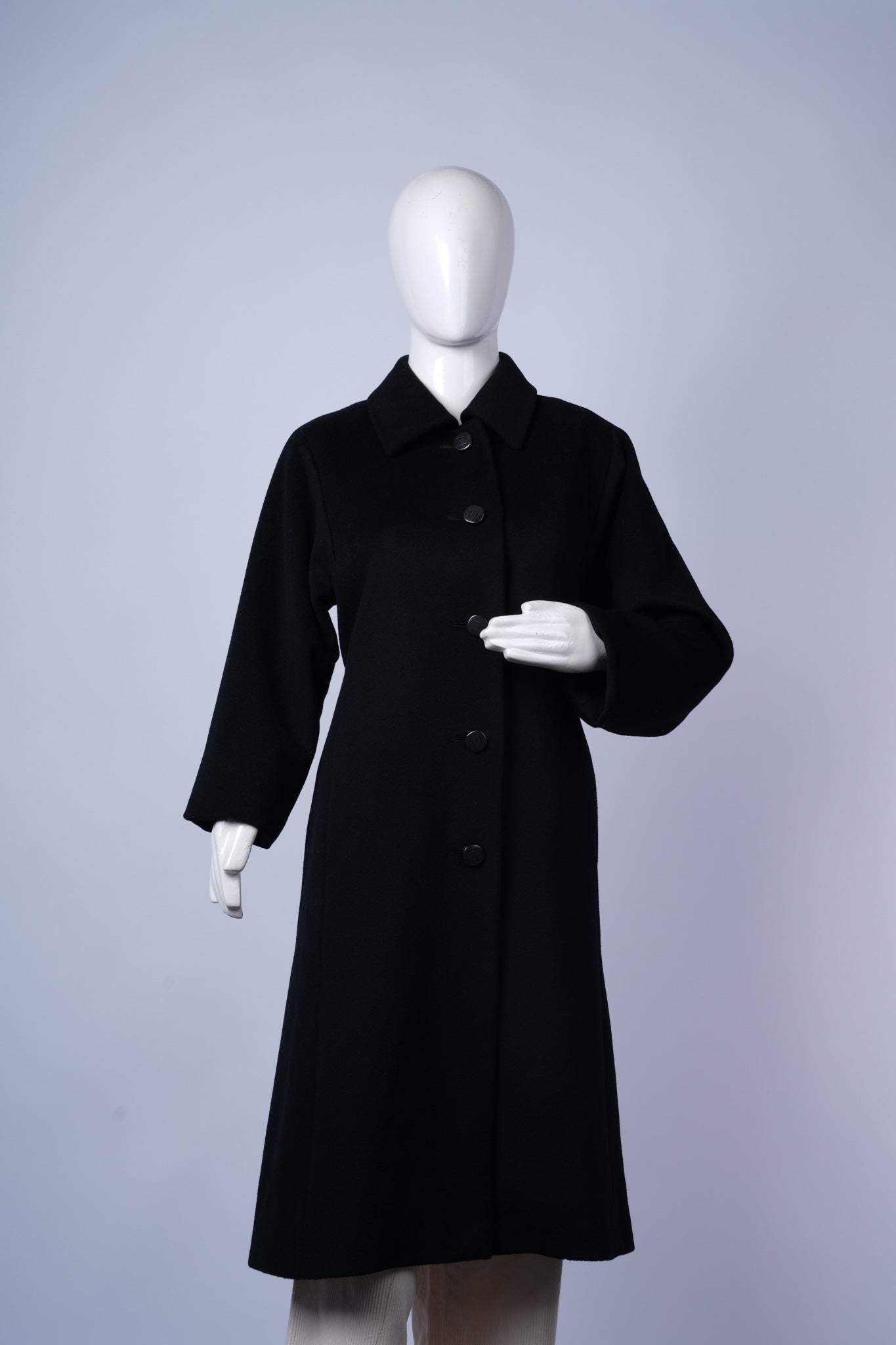Vintage-inspired wool overcoat displayed on hanger
